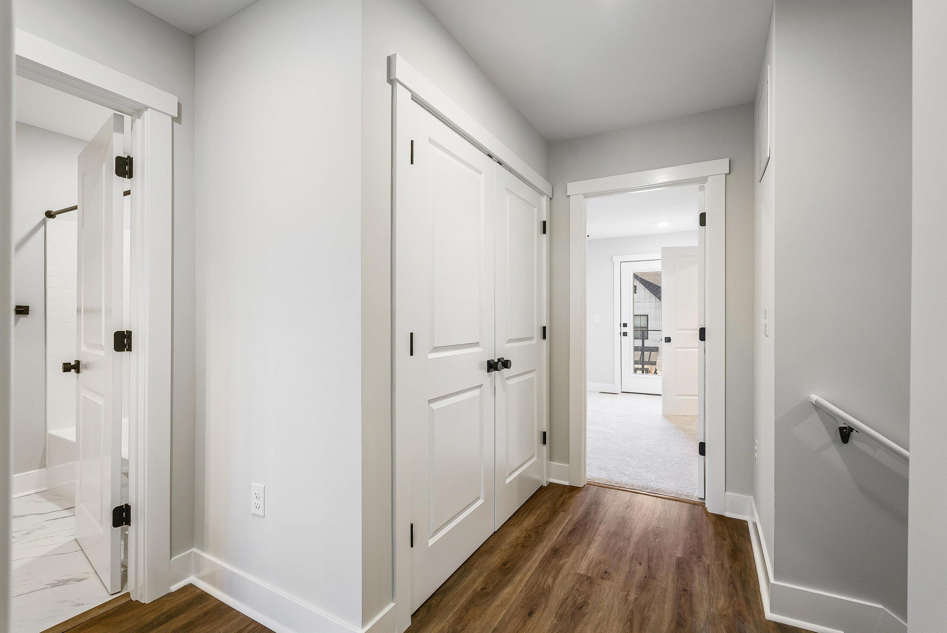 Upstairs hallway features a laundry room and access to primary suite, 2nd full bath and 2 bedrooms Upstairs hallway features a laundry room and access to primary suite, 2nd full bath and 2 bedrooms