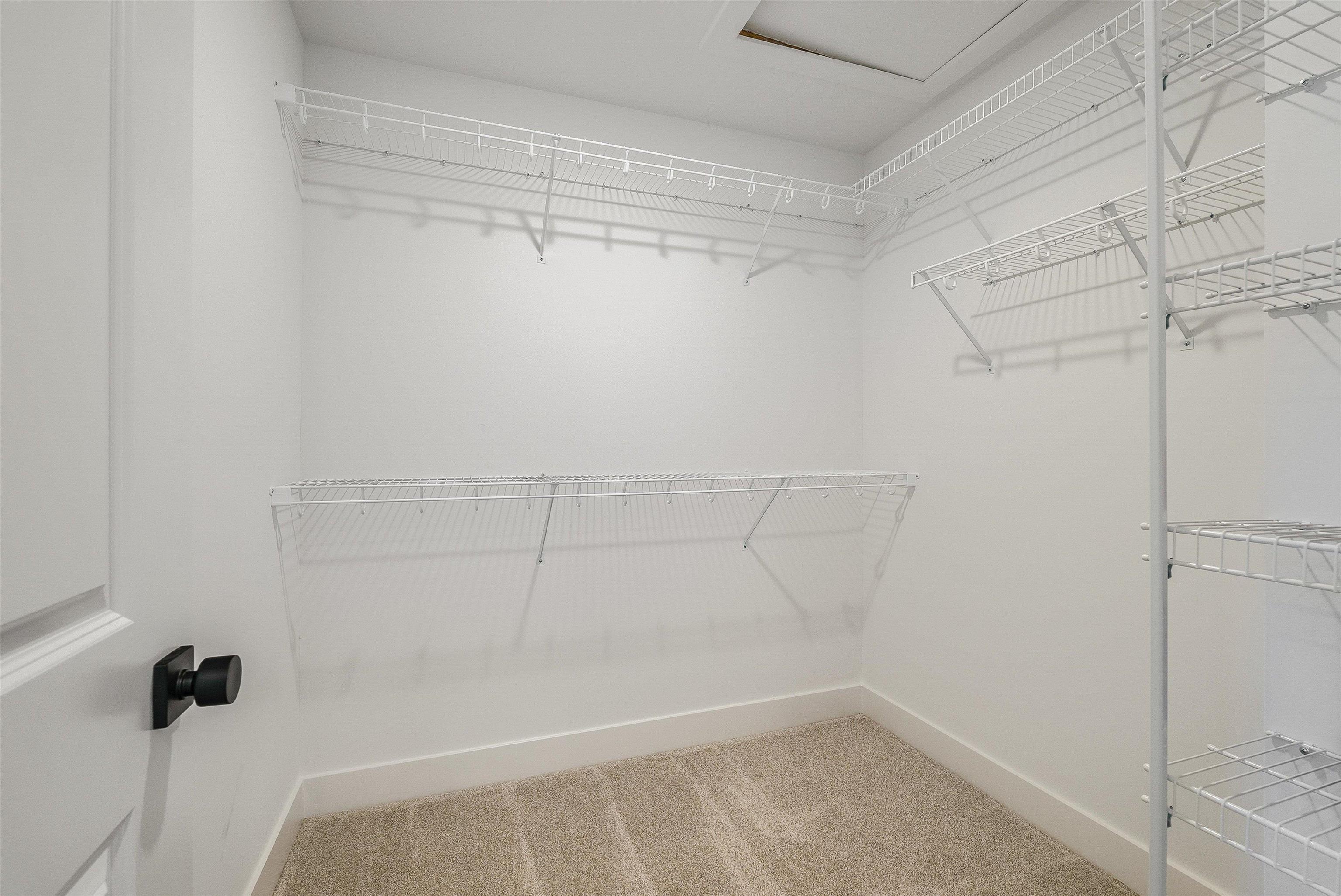 Spacious primary bedroom has 2 walk in closets and an en suite bath. Spacious primary bedroom has 2 walk in closets and an en suite bath.