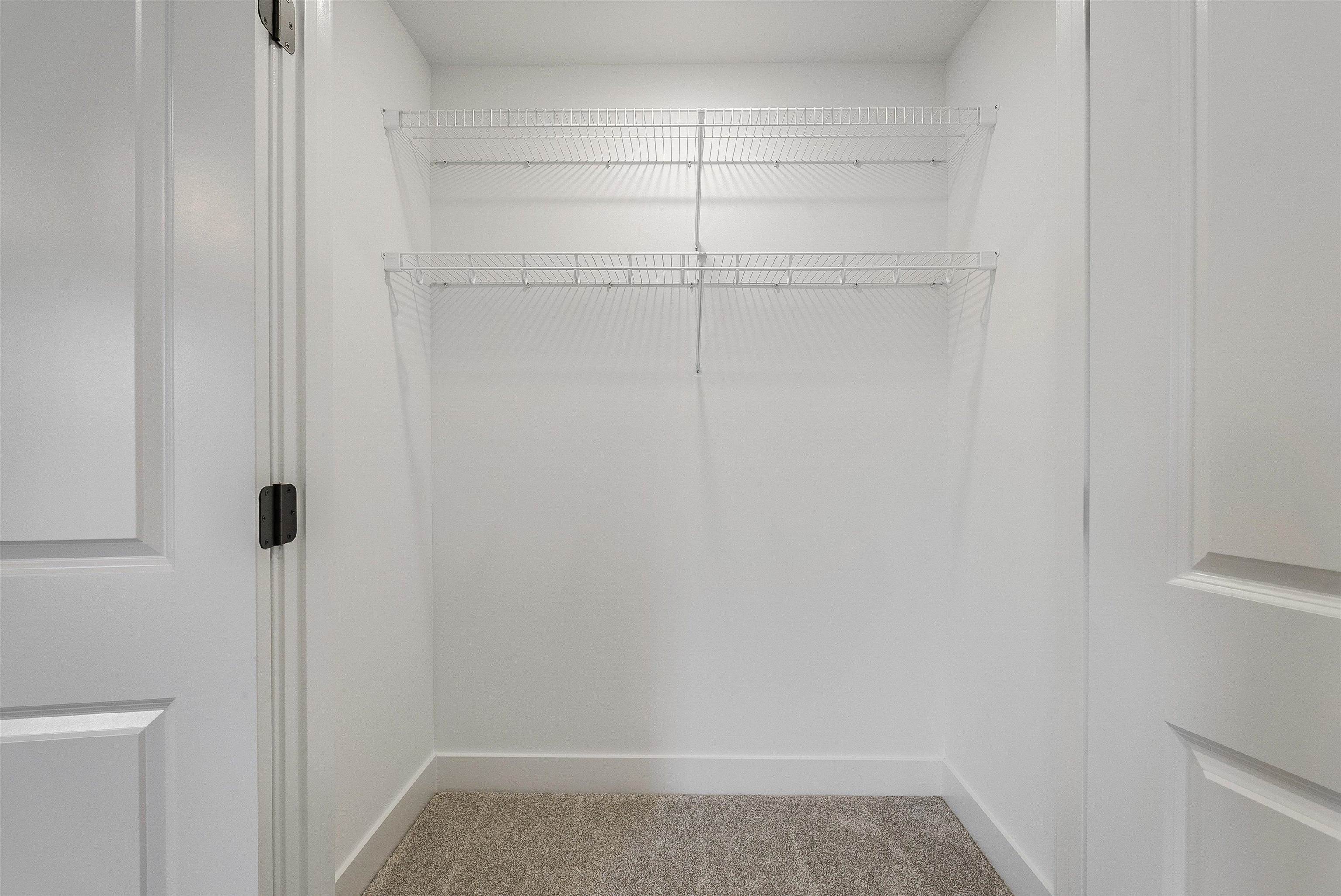 Spacious primary bedroom has 2 walk in closets and an en suite bath. Spacious primary bedroom has 2 walk in closets and an en suite bath.