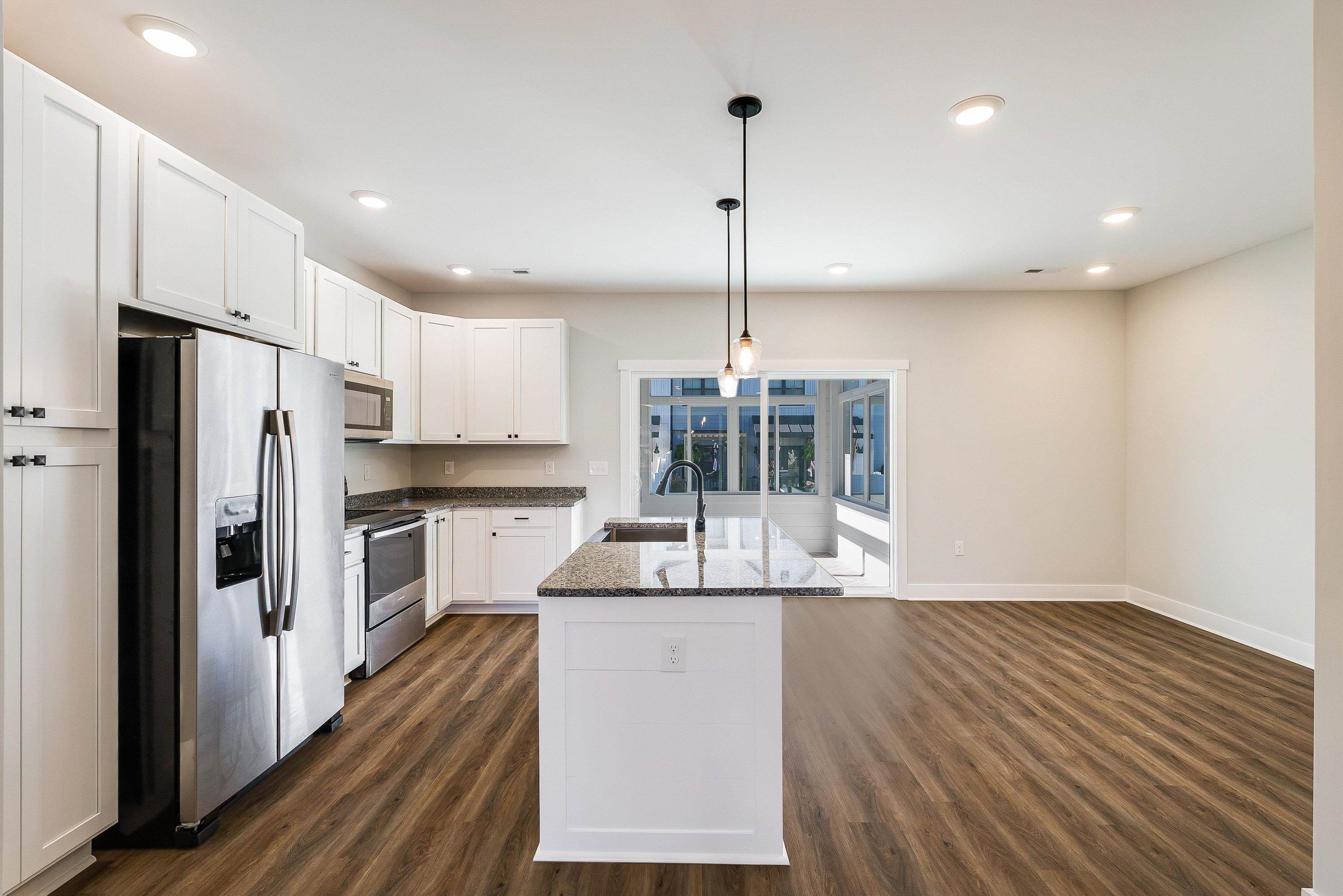 Kitchen features a large island and is open to dining area and living room Kitchen features a large island and is open to dining area and living room