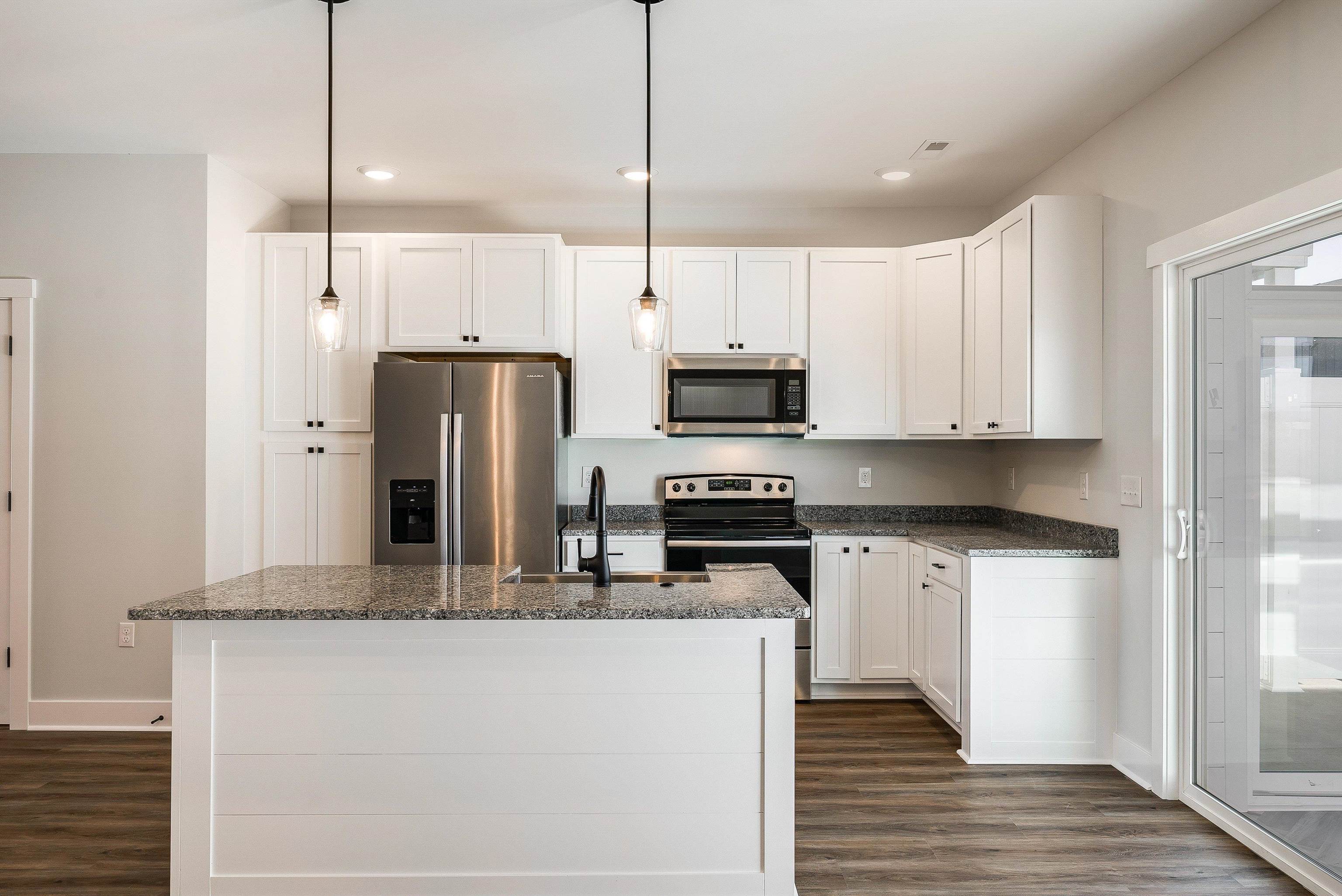 Kitchen features a large island and is open to dining area and living room Kitchen features a large island and is open to dining area and living room