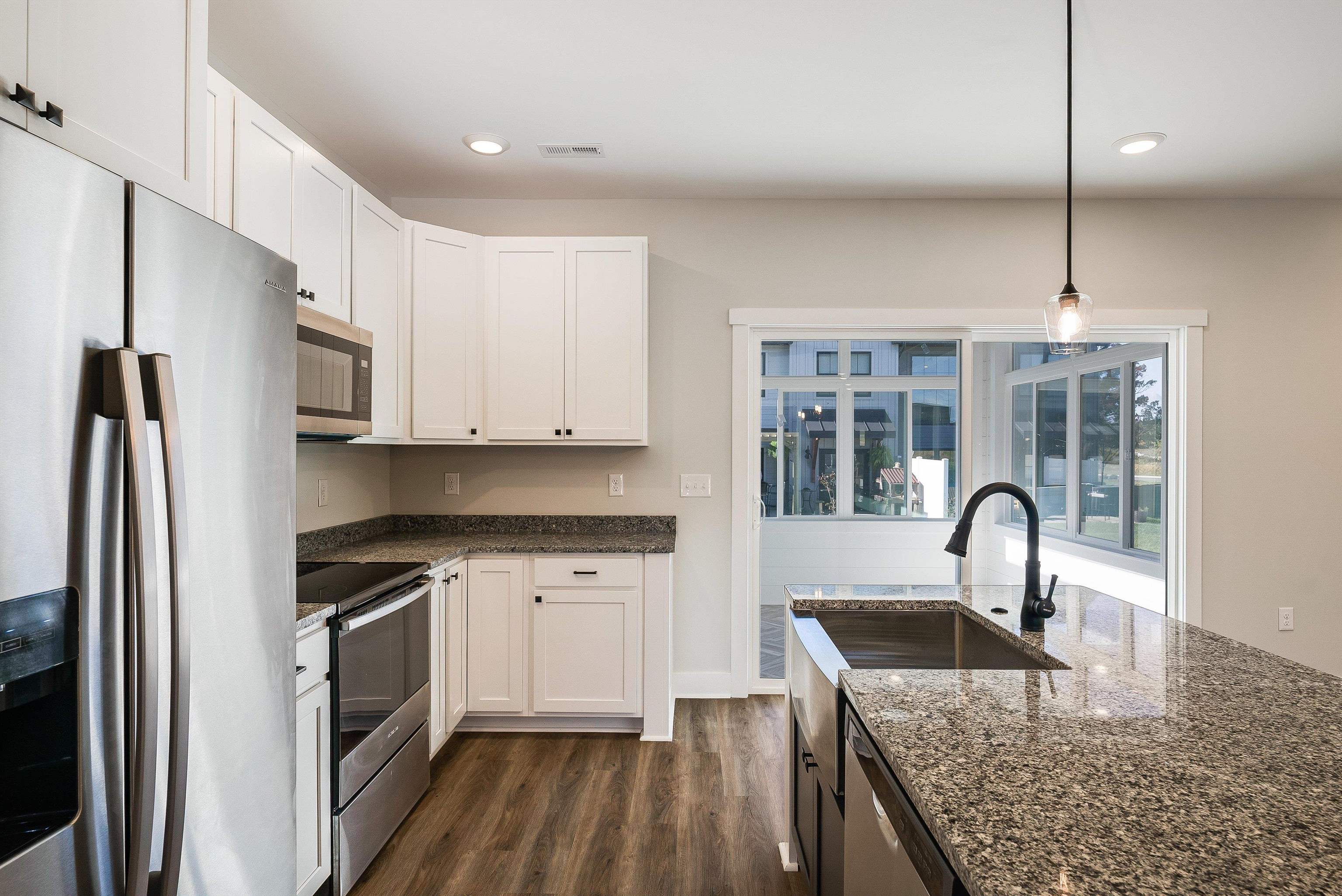 Kitchen features a large island and is open to dining area and living room Kitchen features a large island and is open to dining area and living room