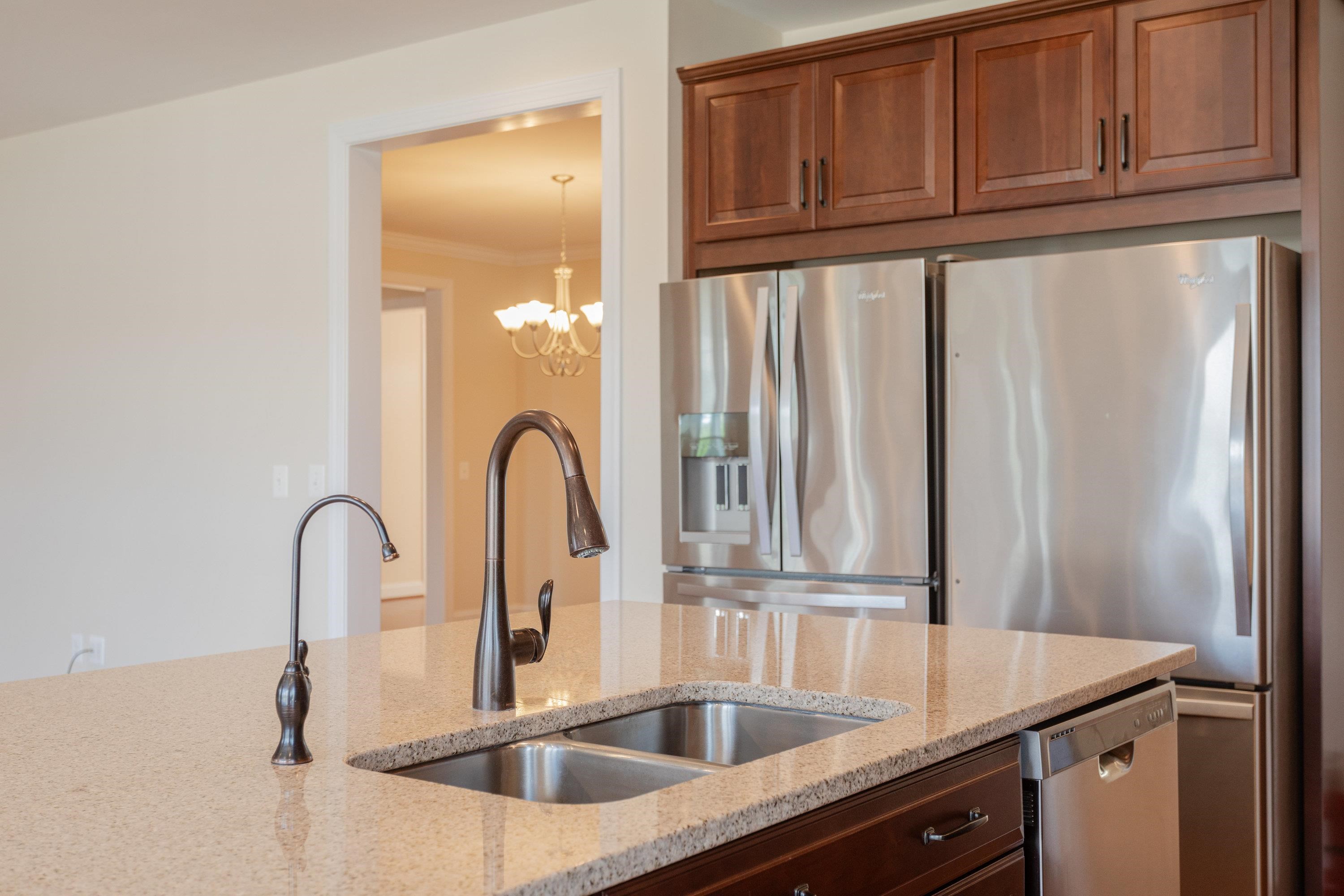 This open concept kitchen features many upgrades throughout.  A few include stainless steel appliances, two refrigerators, recessed lighting, granite counter-tops, hardwood flooring, breakfast bar, and plenty of space for an additional dining space.