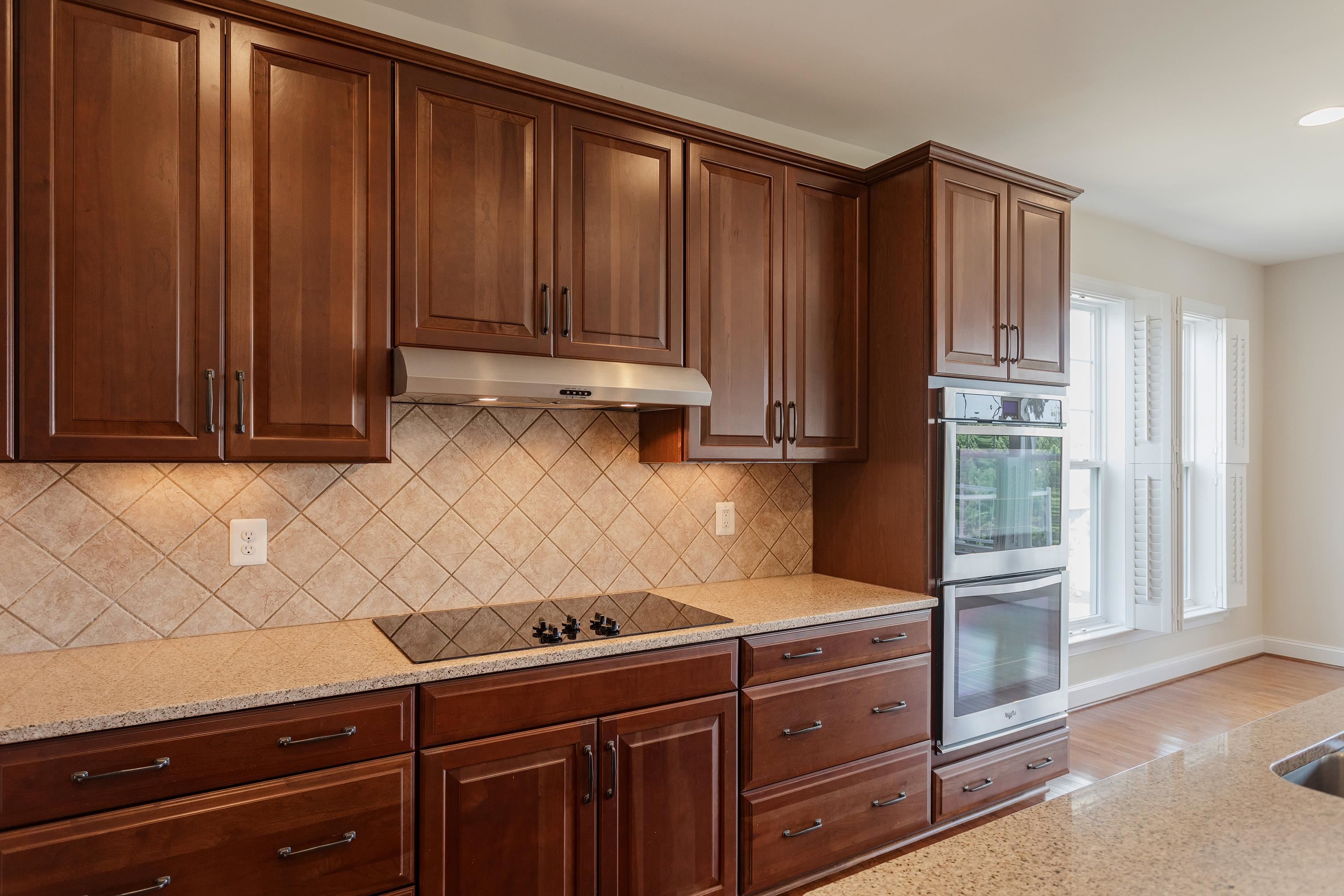 This open concept kitchen features many upgrades throughout.  A few include stainless steel appliances, two refrigerators, recessed lighting, granite counter-tops, hardwood flooring, breakfast bar, and plenty of space for an additional dining space.