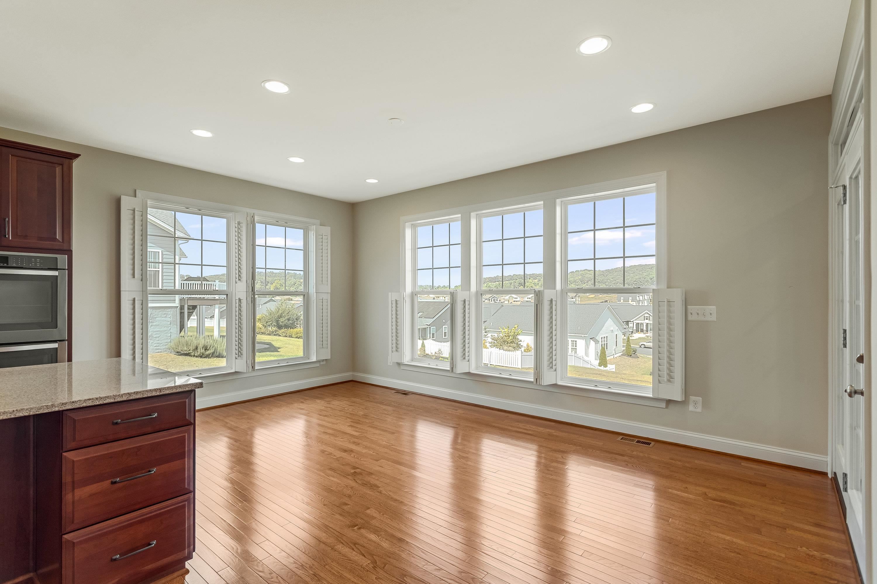 This dining space is located directly off the kitchen and offers hardwood flooring throughout, large windows, and plenty of space for a table and chairs set!
