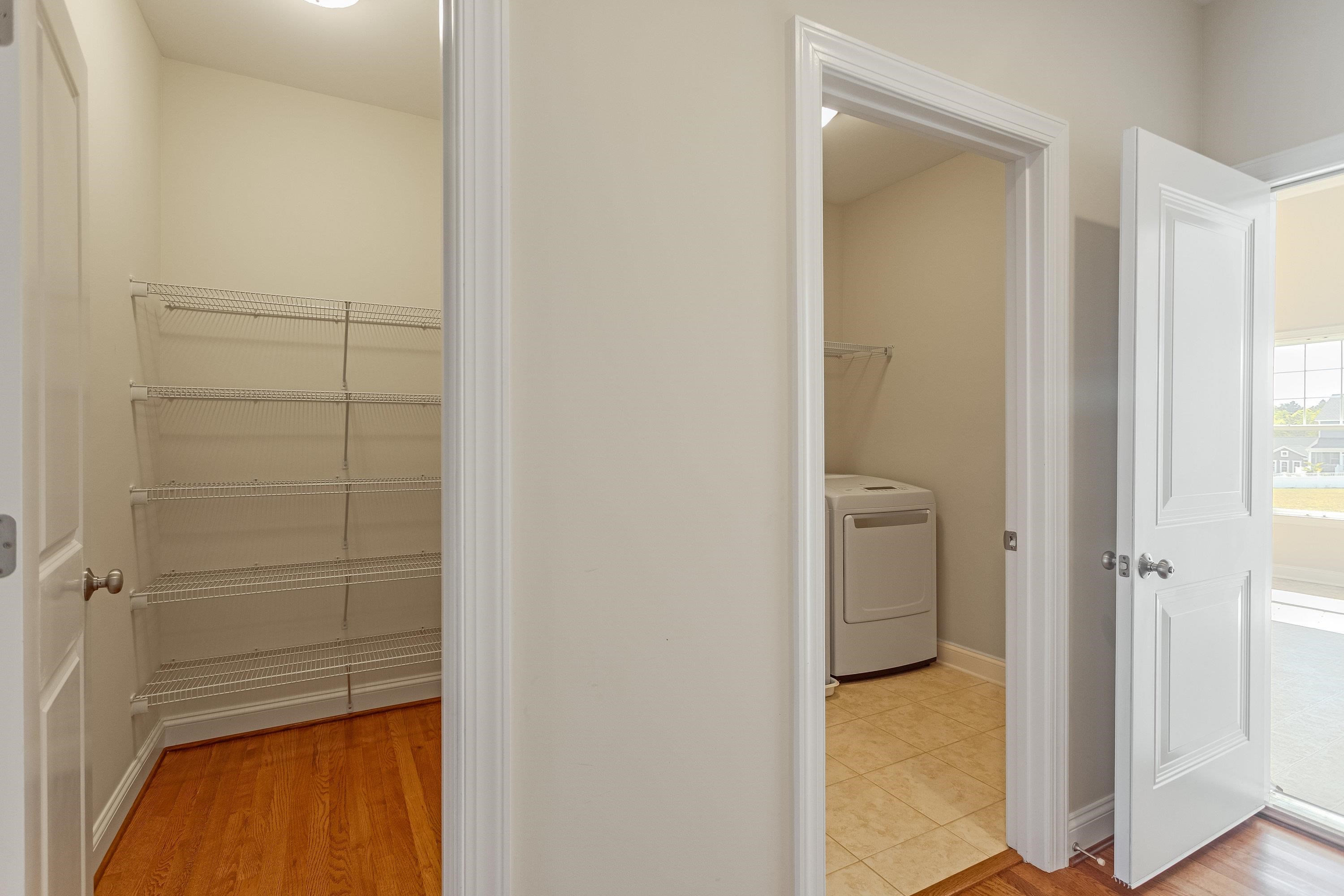 Right outside the kitchen space is a large pantry area with shelving.  The laundry room features a utility sink and full size washer & dryer hookups.