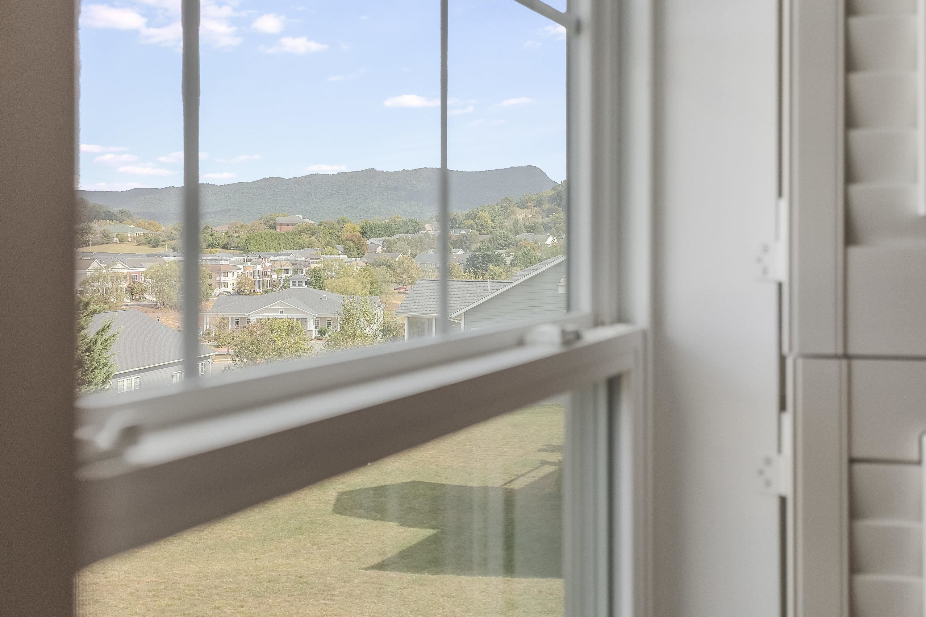 The primary bedroom features beautiful views of the nearby mountains.
