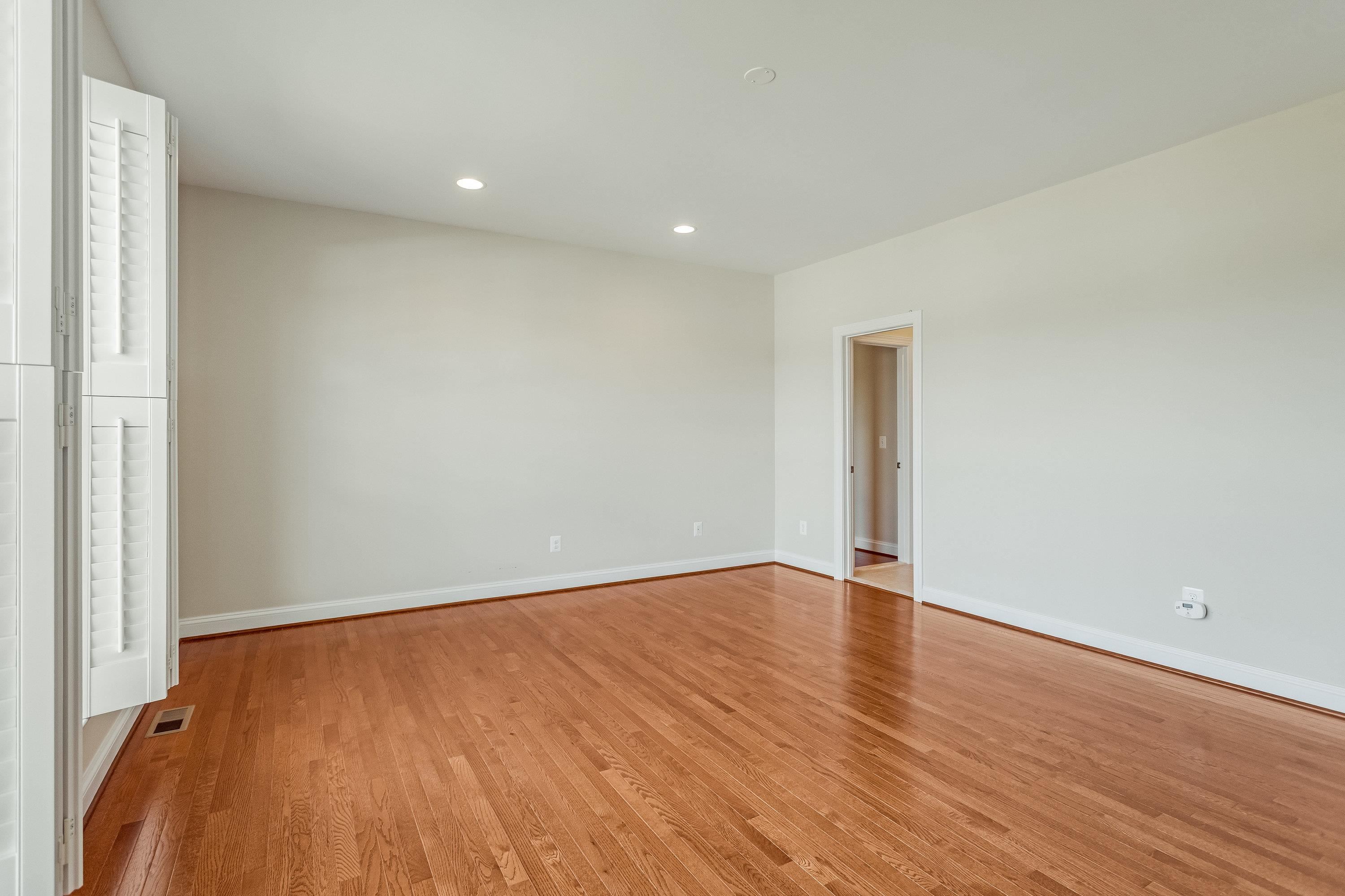 The very large primary bedroom offers hardwood flooring throughout, large windows, recessed lighting, spacious walk-in closet, and full attached bathroom.