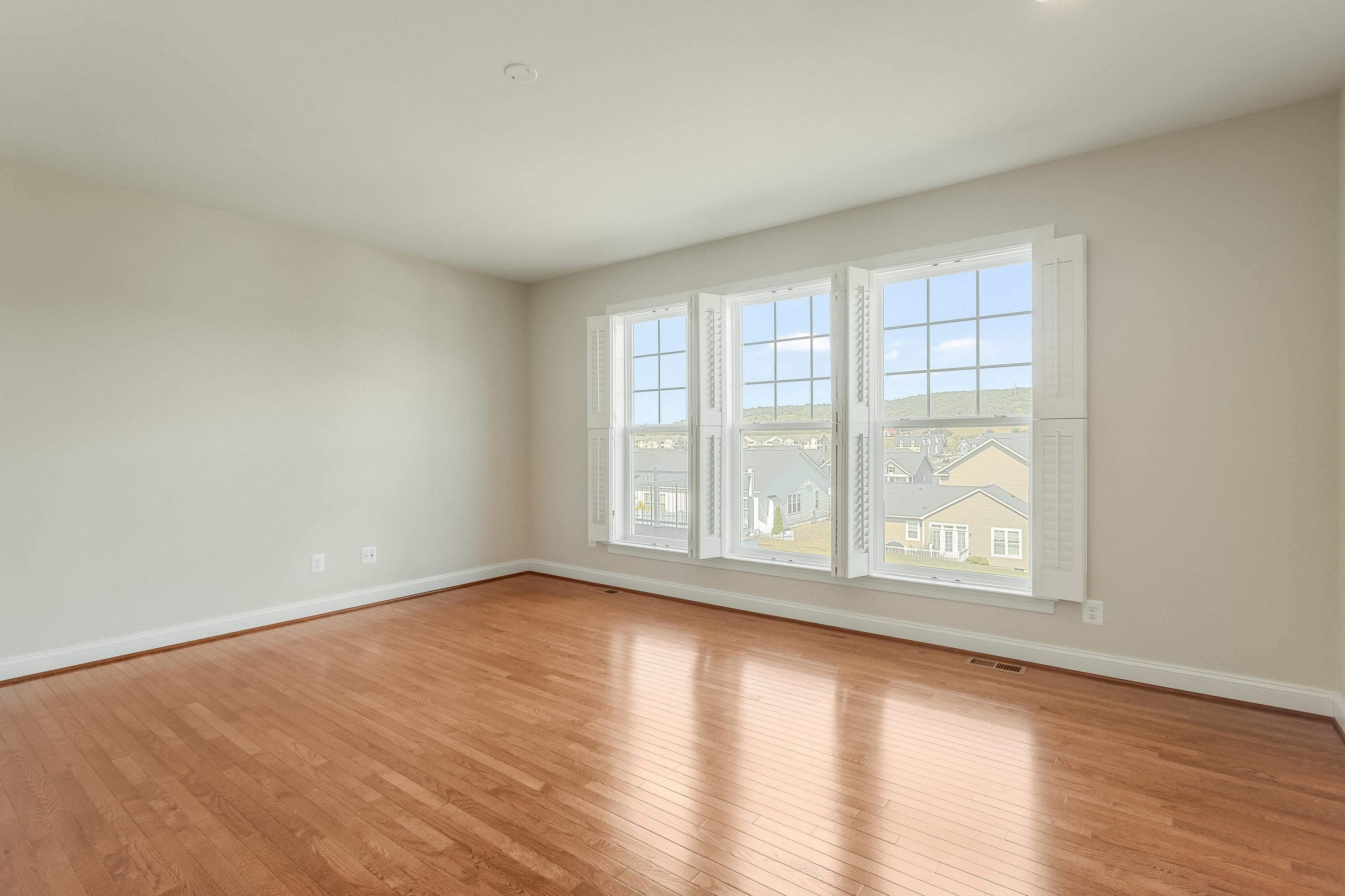 The very large primary bedroom offers hardwood flooring throughout, large windows, recessed lighting, spacious walk-in closet, and full attached bathroom.