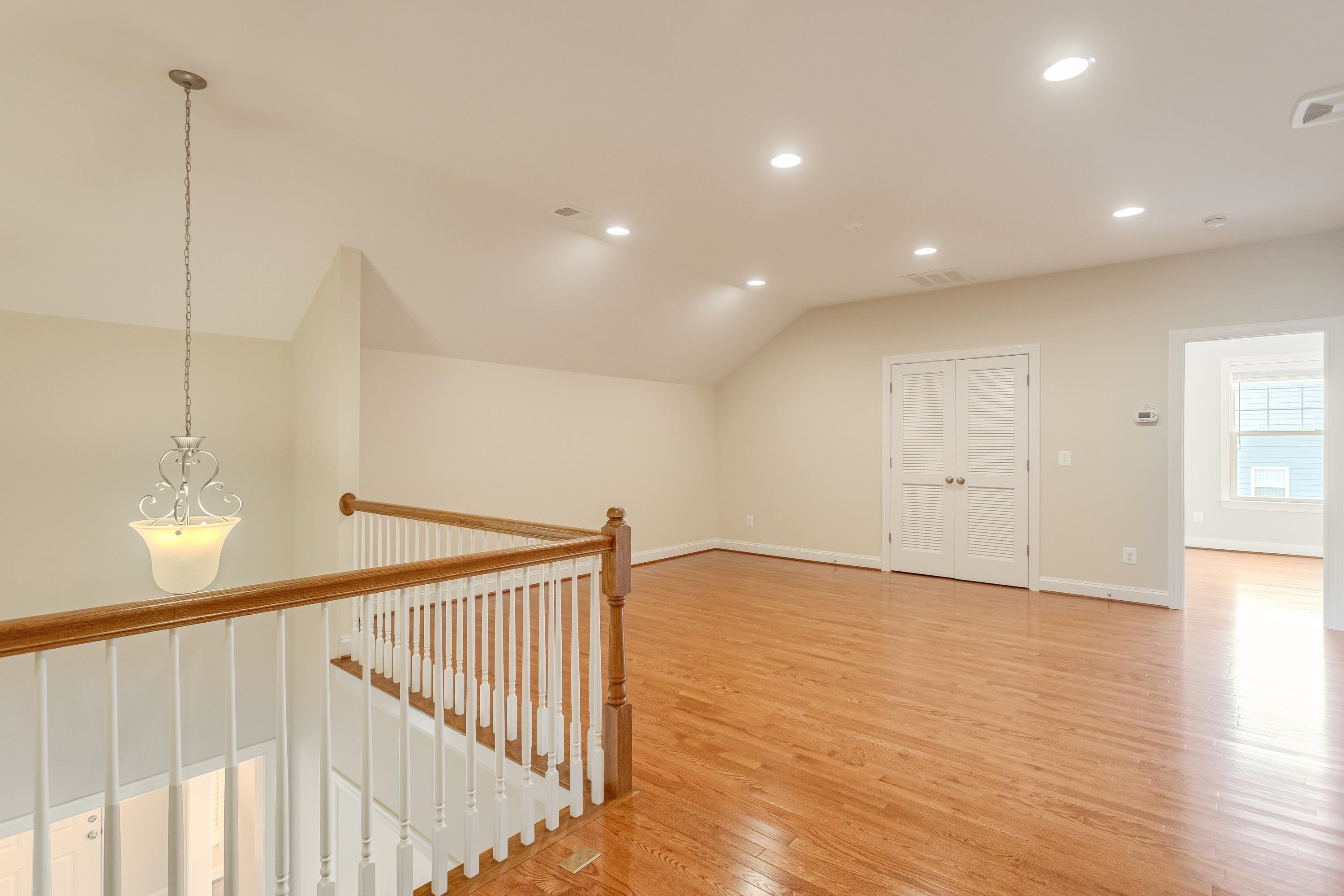 This very open bonus room space features recessed lighting, hardwood flooring throughout, and plenty of space for use as a playroom, additional living room, and much more!