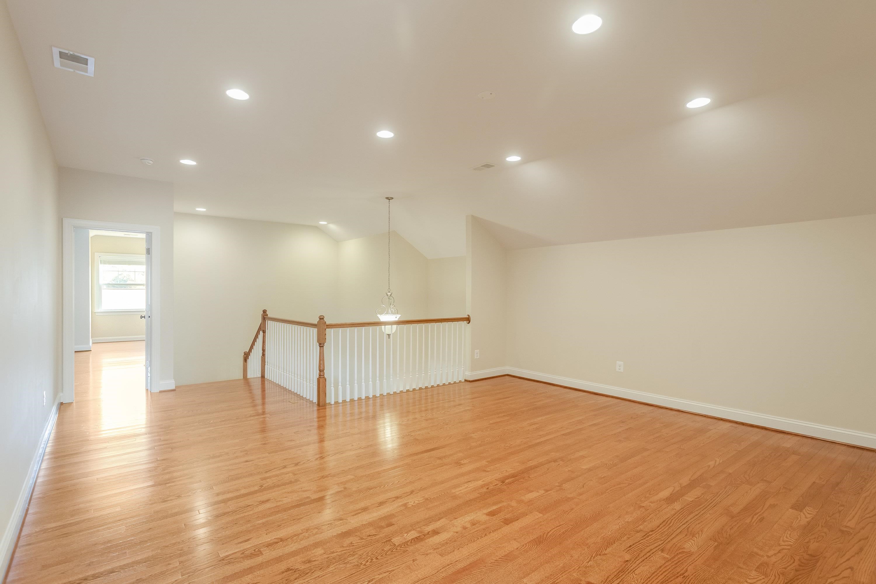 This very open bonus room space features recessed lighting, hardwood flooring throughout, and plenty of space for use as a playroom, additional living room, and much more!