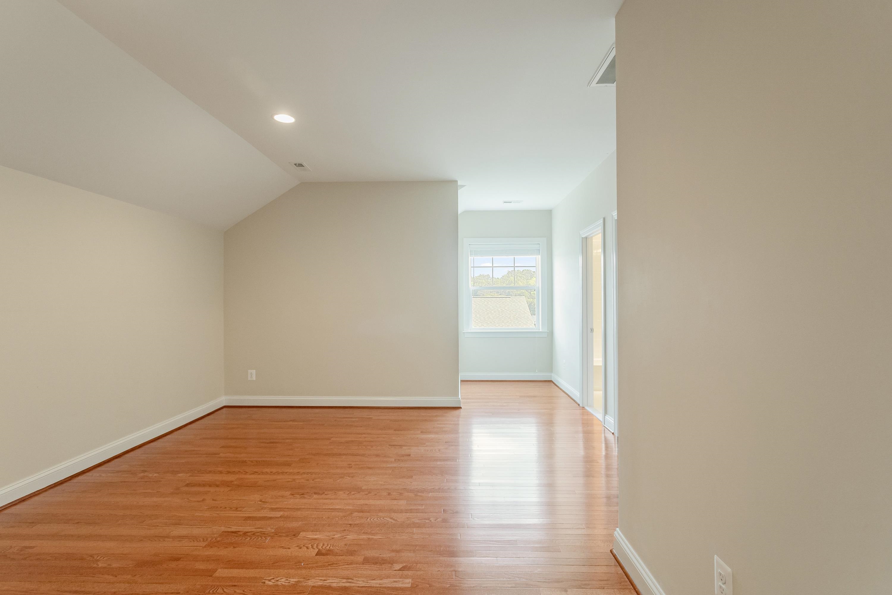 This third bedroom is on the upper level of the home and offers hardwood flooring throughout, large windows, and spacious closet.