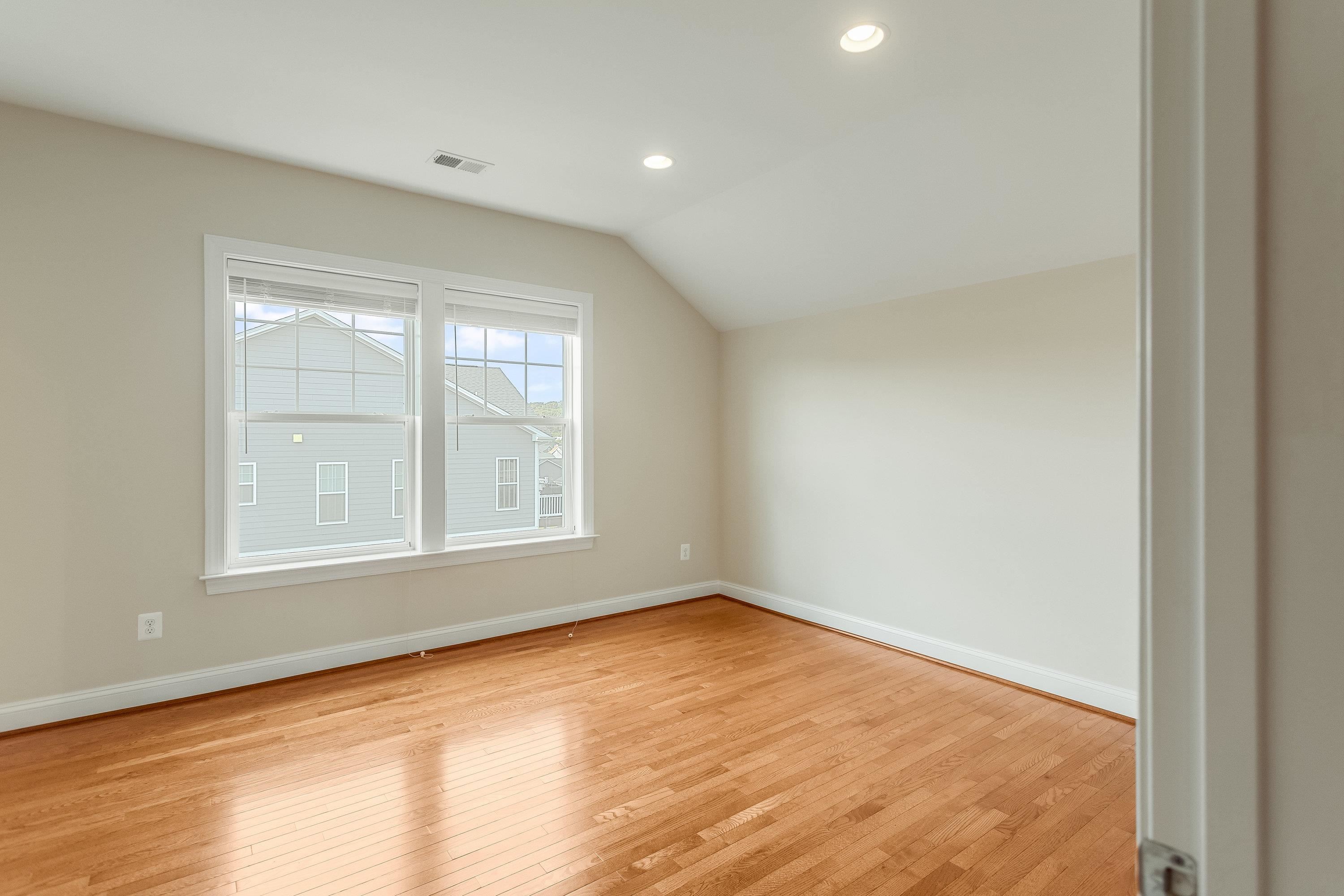 This fourth bedroom is on the upper level of the home and offers hardwood flooring throughout, large windows, and spacious closet.
