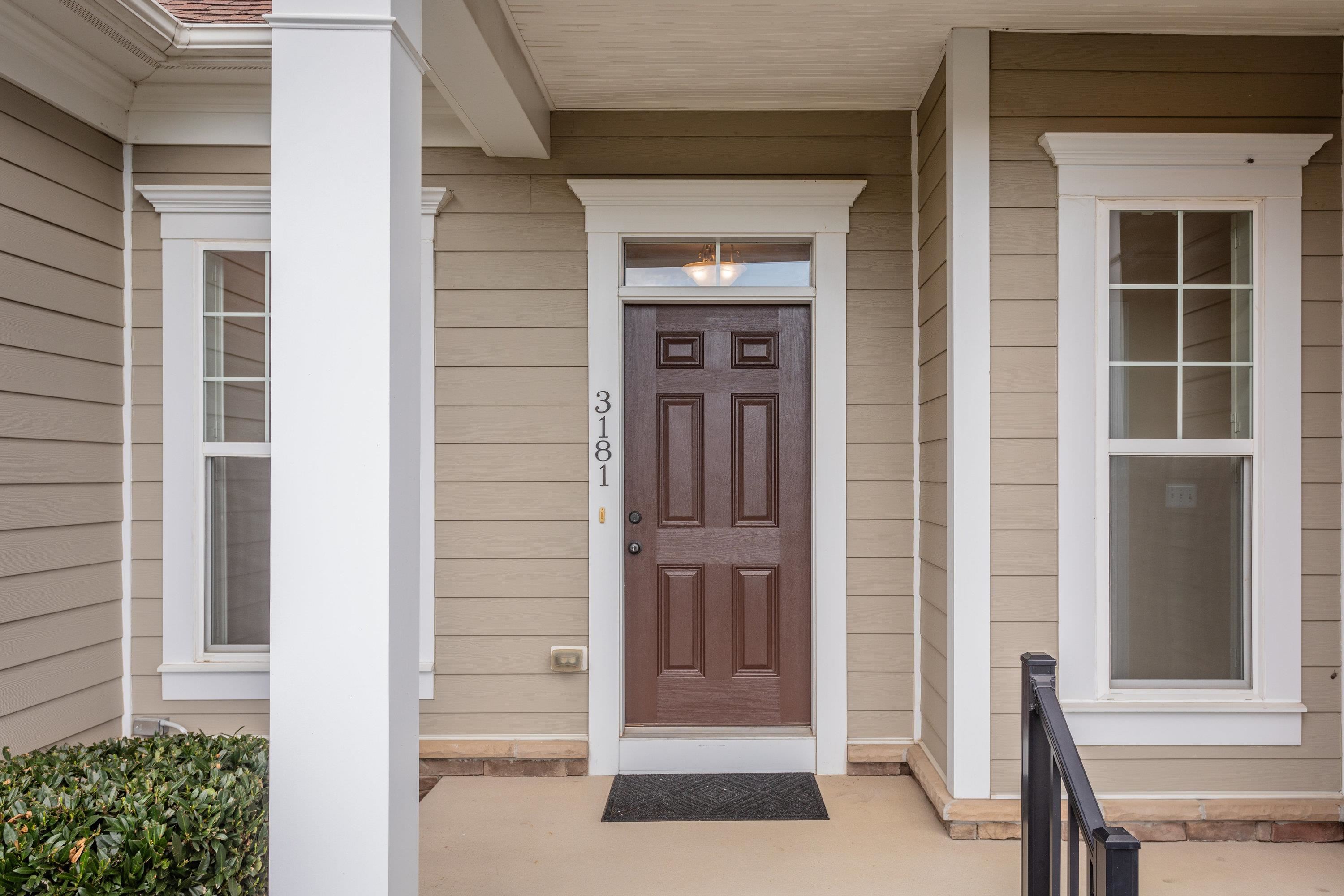 The front view of the upgraded, comtemporary home located in the Preston Lake community.  The front view highlights the large front porch, two-car garage, beautiful landscaping, and much more!