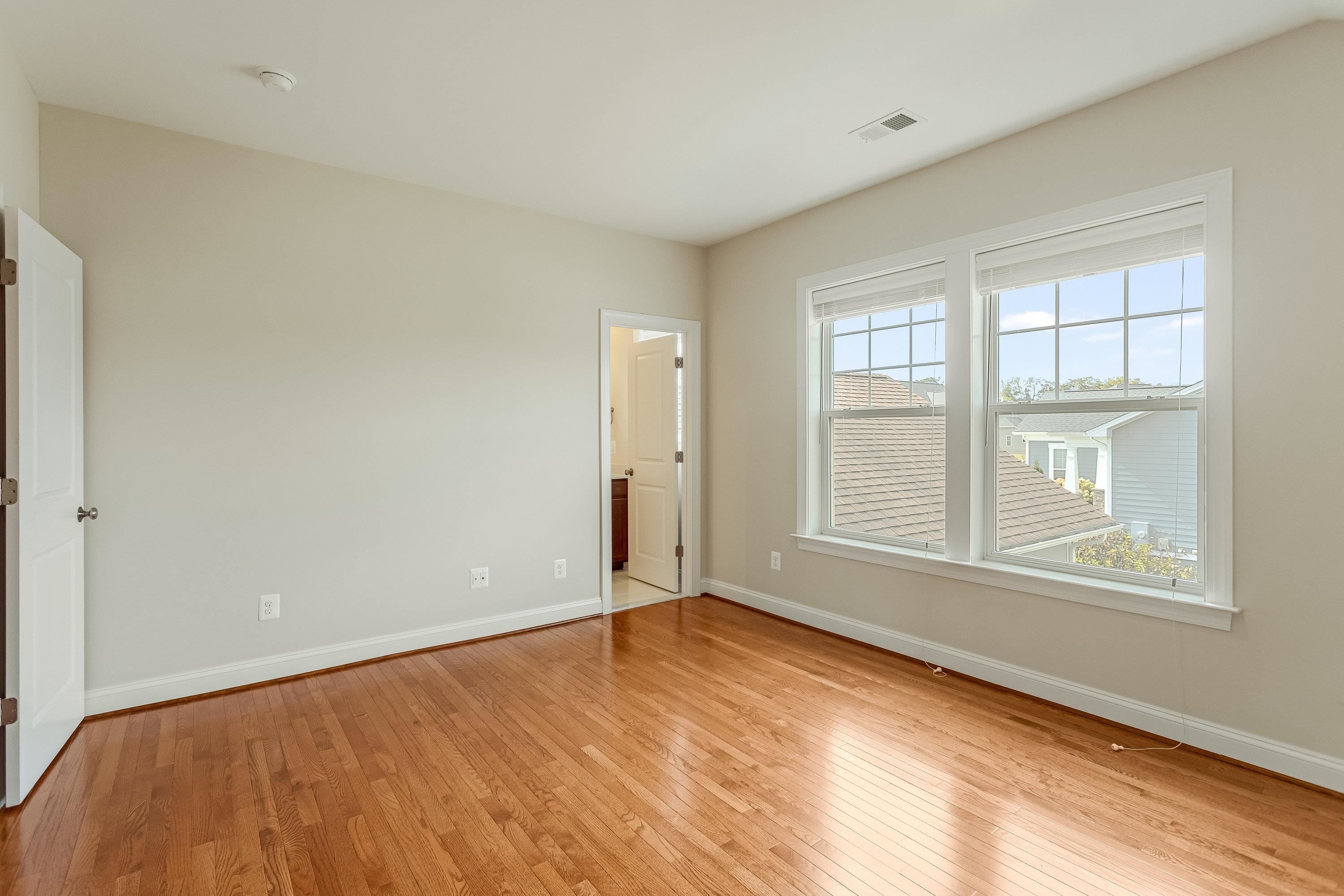 This fourth bedroom is on the upper level of the home and offers hardwood flooring throughout, large windows, and spacious closet.