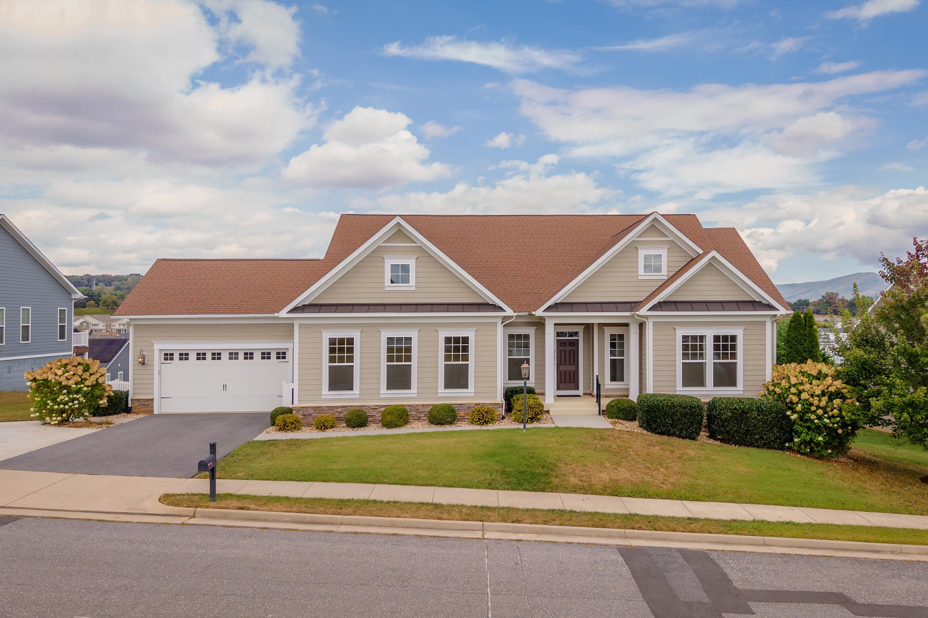 The front view of the upgraded, comtemporary home located in the Preston Lake community.  The front view highlights the large front porch, two-car garage, beautiful landscaping, and much more!