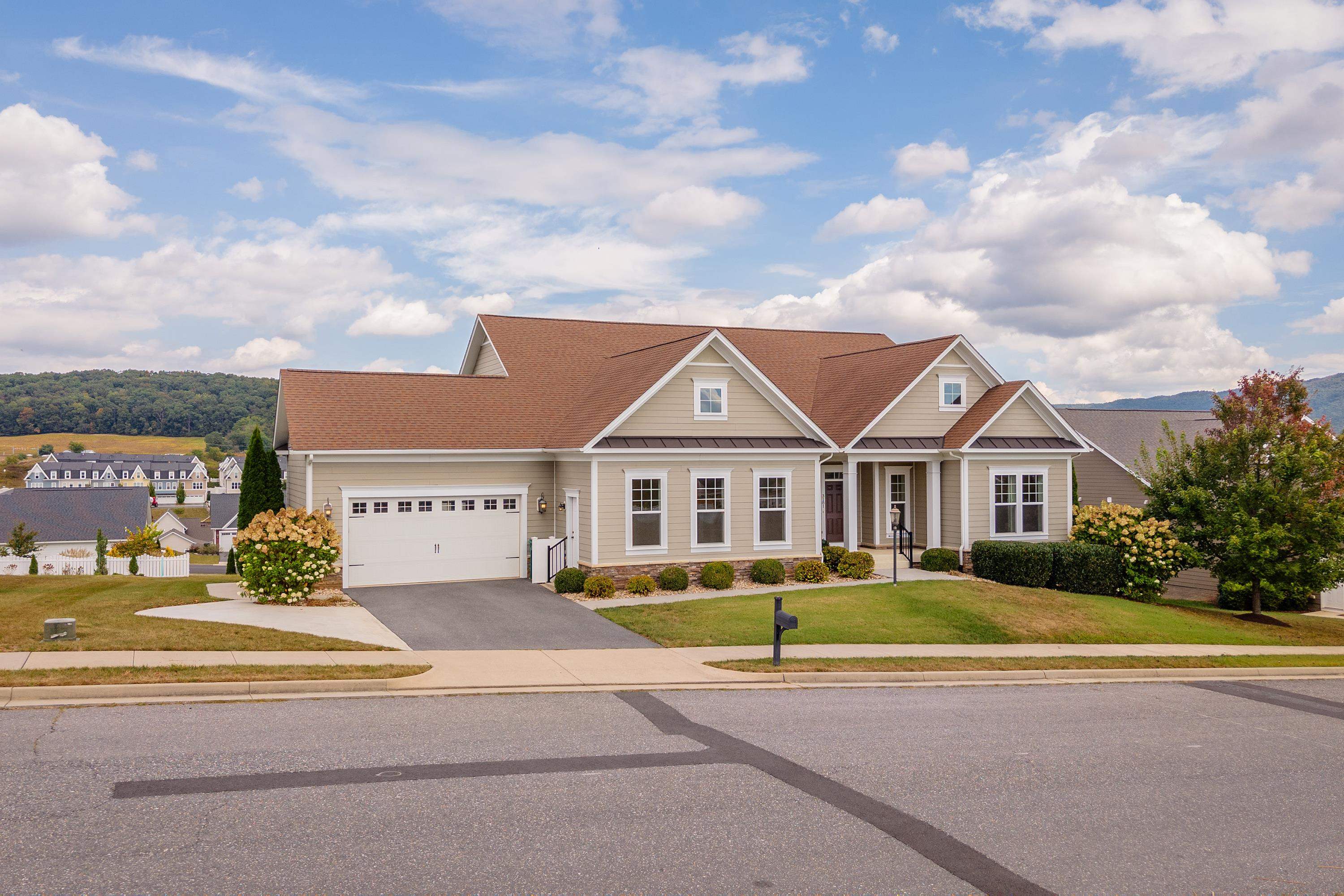 The front view of the upgraded, comtemporary home located in the Preston Lake community.  The front view highlights the large front porch, two-car garage, beautiful landscaping, and much more!