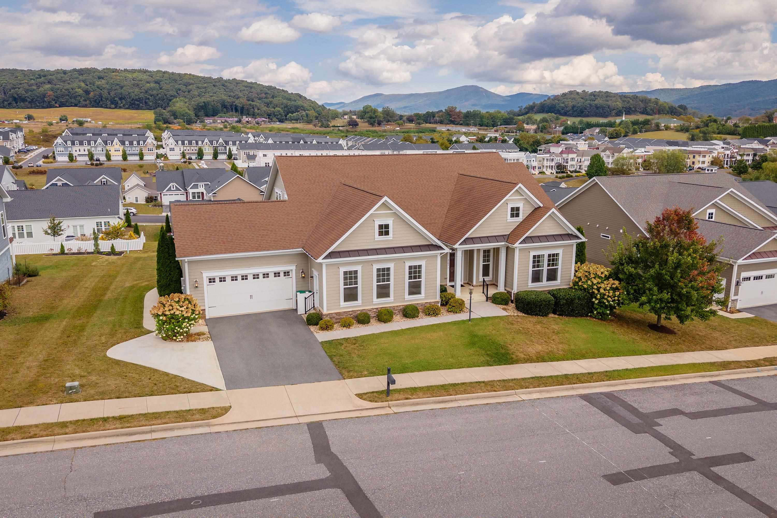 The front view of the upgraded, comtemporary home located in the Preston Lake community.  The front view highlights the large front porch, two-car garage, beautiful landscaping, and much more!