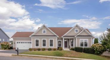 The front view of the upgraded, comtemporary home located in the Preston Lake community.  The front view highlights the large front porch, two-car garage, beautiful landscaping, and much more!