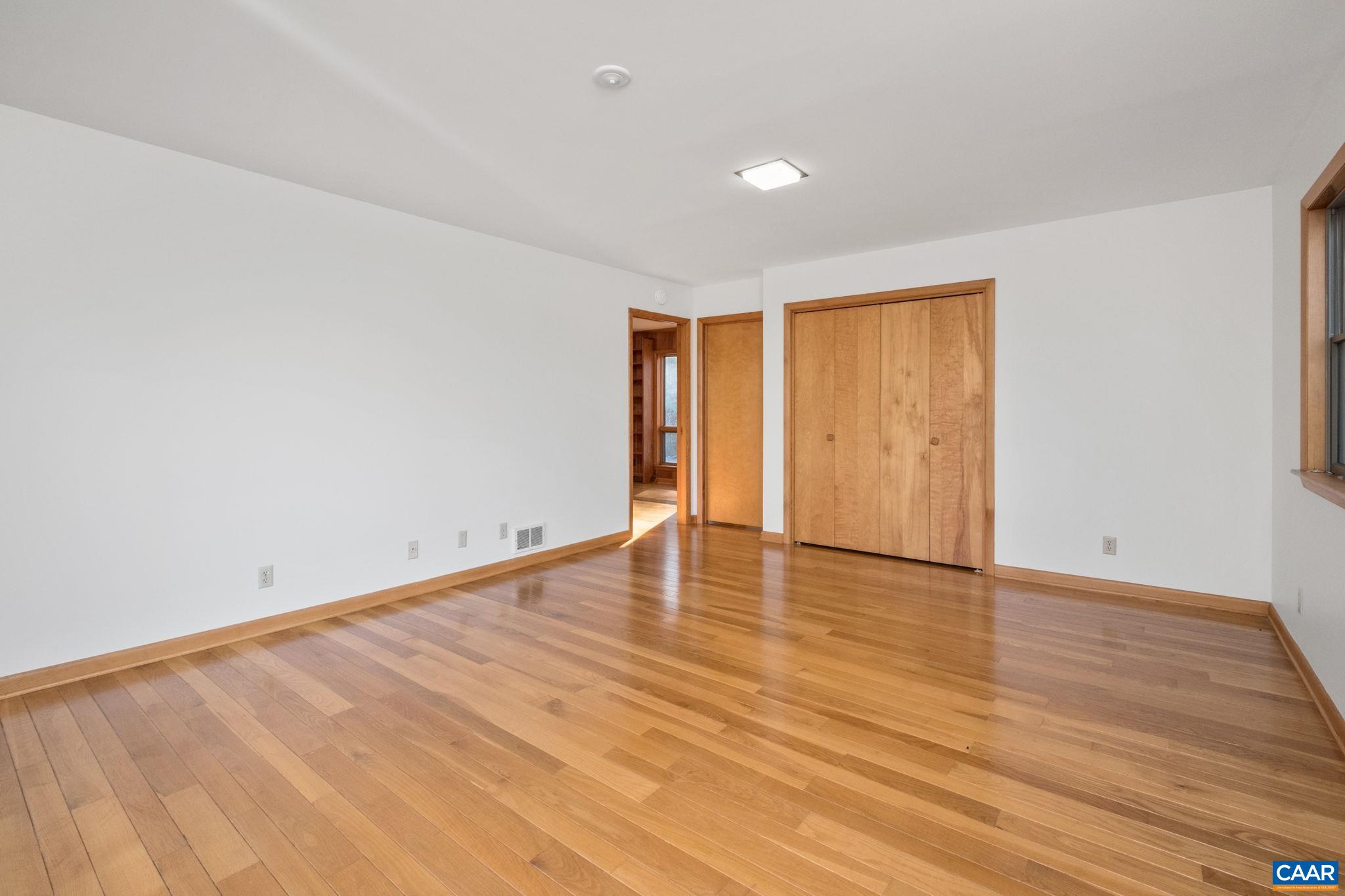 Loads of natural light - opens to the deck, beautiful hardwood floors, attached bath.