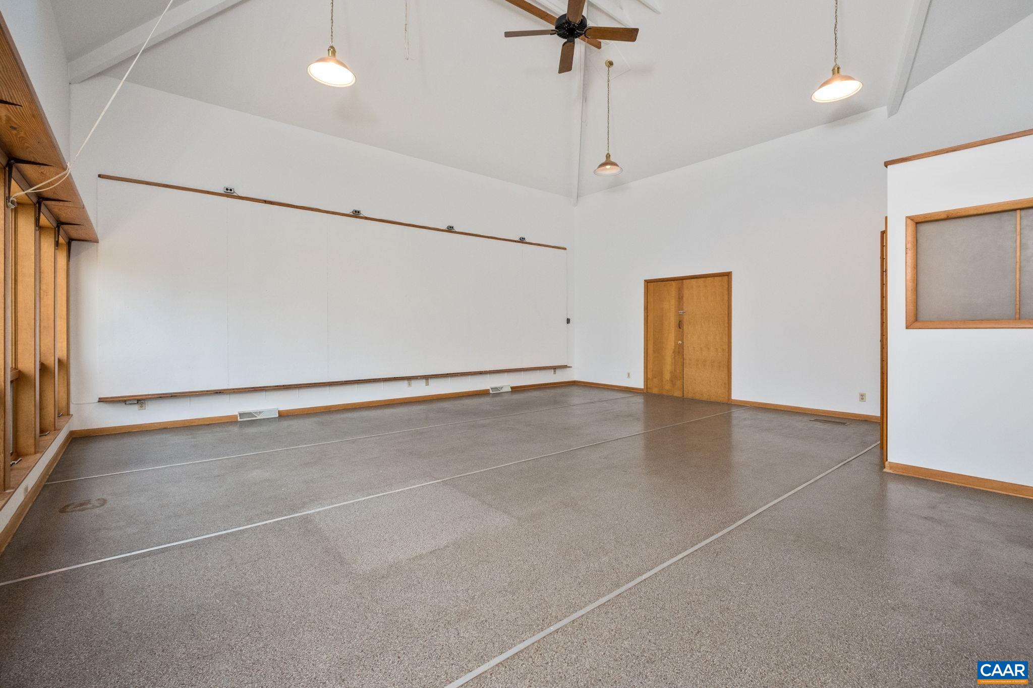 This sutdio is nost an 'extra room' that may be used as a studio  The entire building was designed around the integration of a designated professional massive studio space accessible from both insdie the home or outside from the deck.