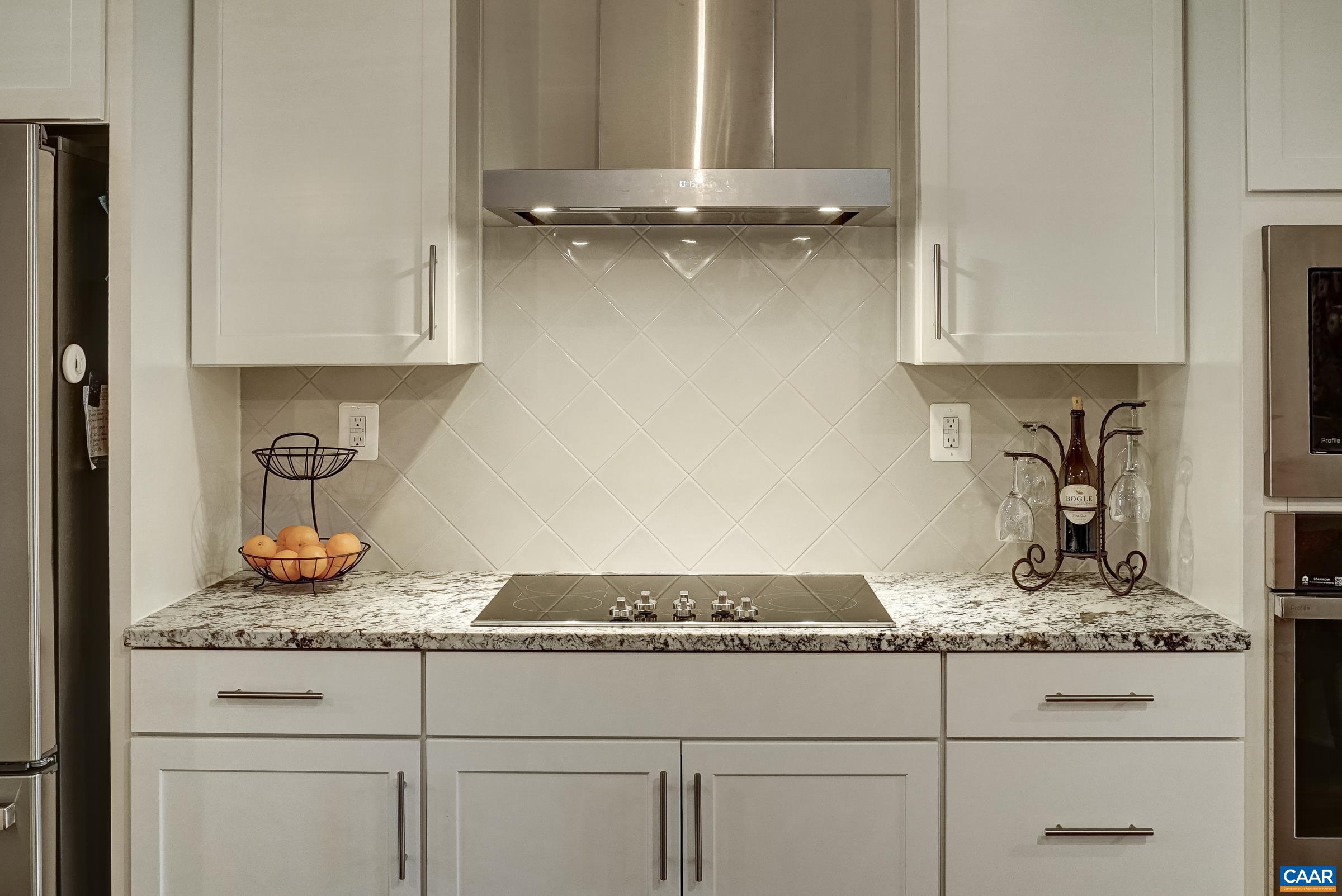 Tile backsplash over range. Tile backsplash over range.