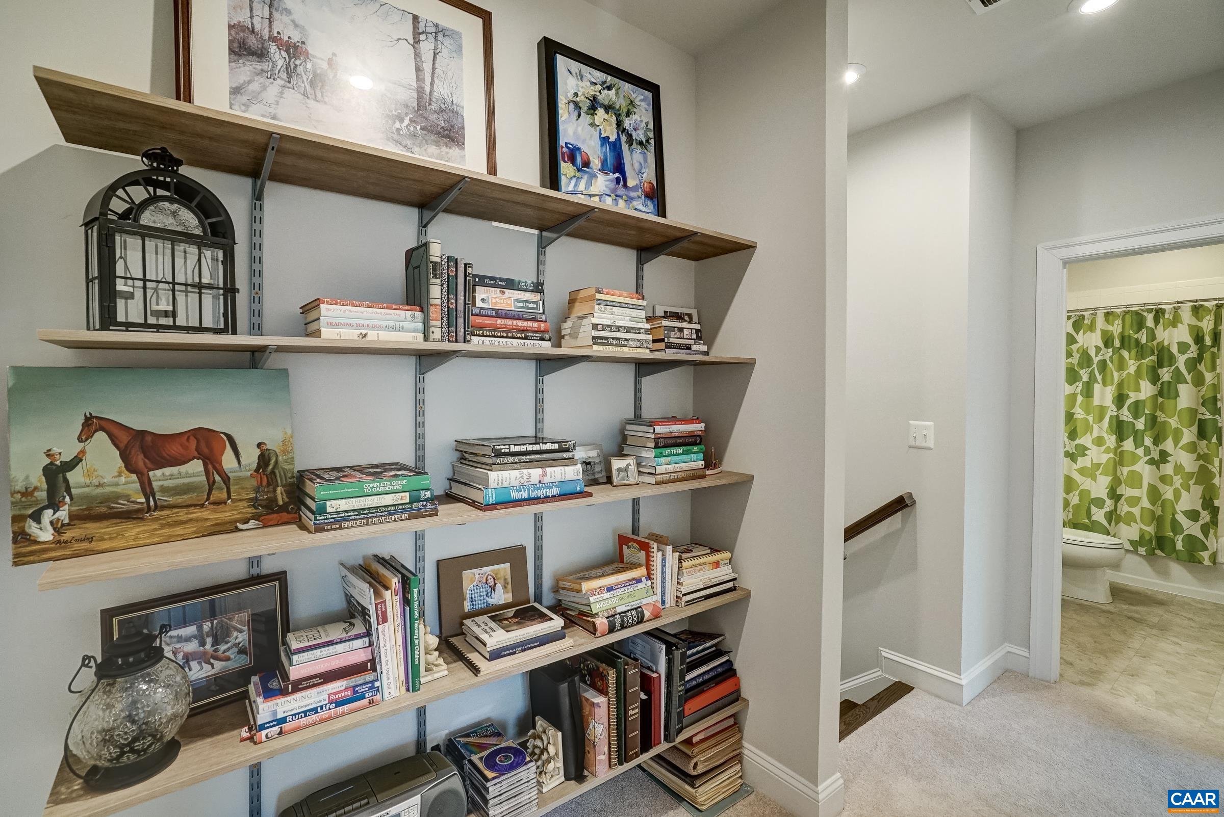 Second floor landing boasts a wall of built-in shelves. Second floor landing boasts a wall of built-in shelves.
