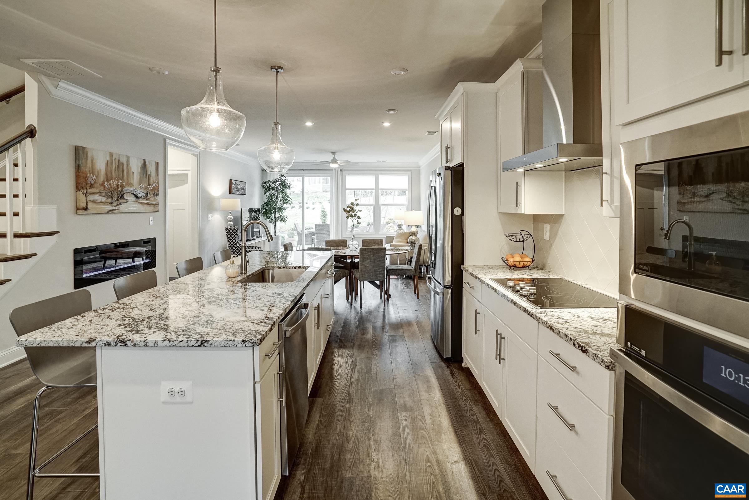 Gourmet ktichen features granite counters, white cabinets, and stainless steel appliances. Gourmet ktichen features granite counters, white cabinets, and stainless steel appliances.