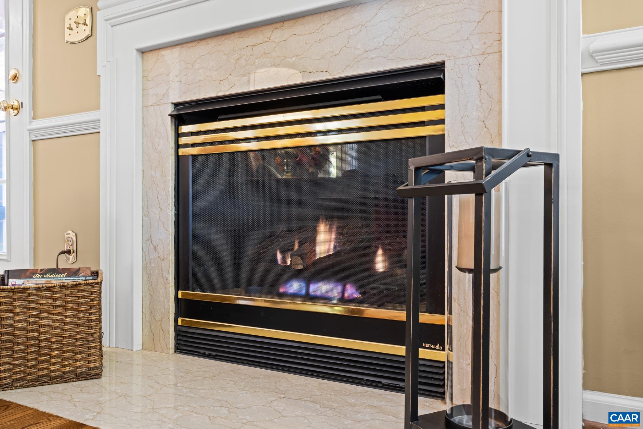 Cozy up by the beautiful gas fireplace, featuring a polished marble surround and hearth, with elegant brass trim. The inviting flames create a warm ambiance, perfect for relaxing on chilly evenings. Cozy up by the beautiful gas fireplace, featuring a polished marble surround and hearth, with elegant brass trim. The inviting flames create a warm ambiance, perfect for relaxing on chilly evenings.