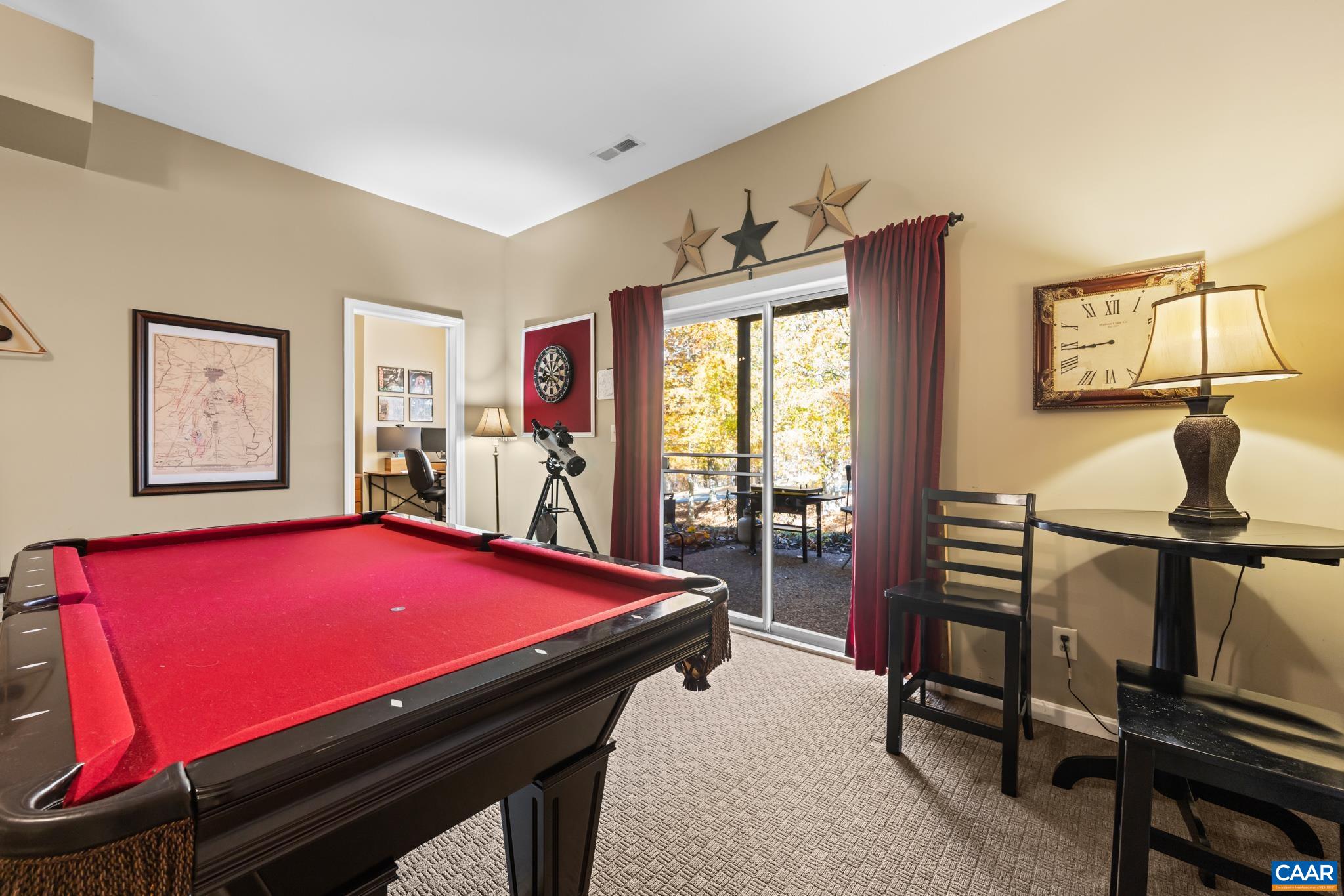 Entertain in the finished basement! This versatile space features a pool table that will come with the house. Leads to an outdoor patio through the sliding glass door. Enjoy warm neutral walls, plush carpet, and a separate adjoining office/den. Entertain in the finished basement! This versatile space features a pool table that will come with the house. Leads to an outdoor patio through the sliding glass door. Enjoy warm neutral walls, plush carpet, and a separate adjoining office/den.