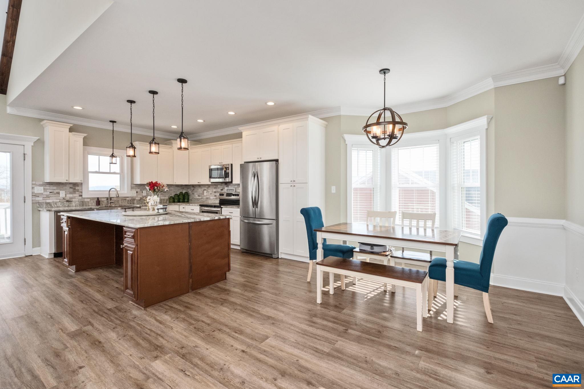 Also in view is the cabinet pantry alongside the refrigerator.