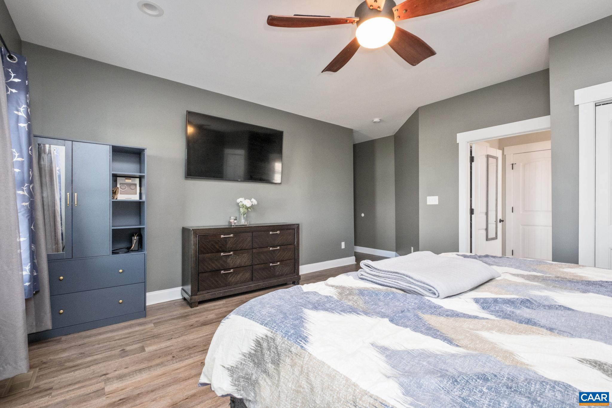 Alternate view of the primary bedroom.  Primary suite is large and features a private hallway and two closets.