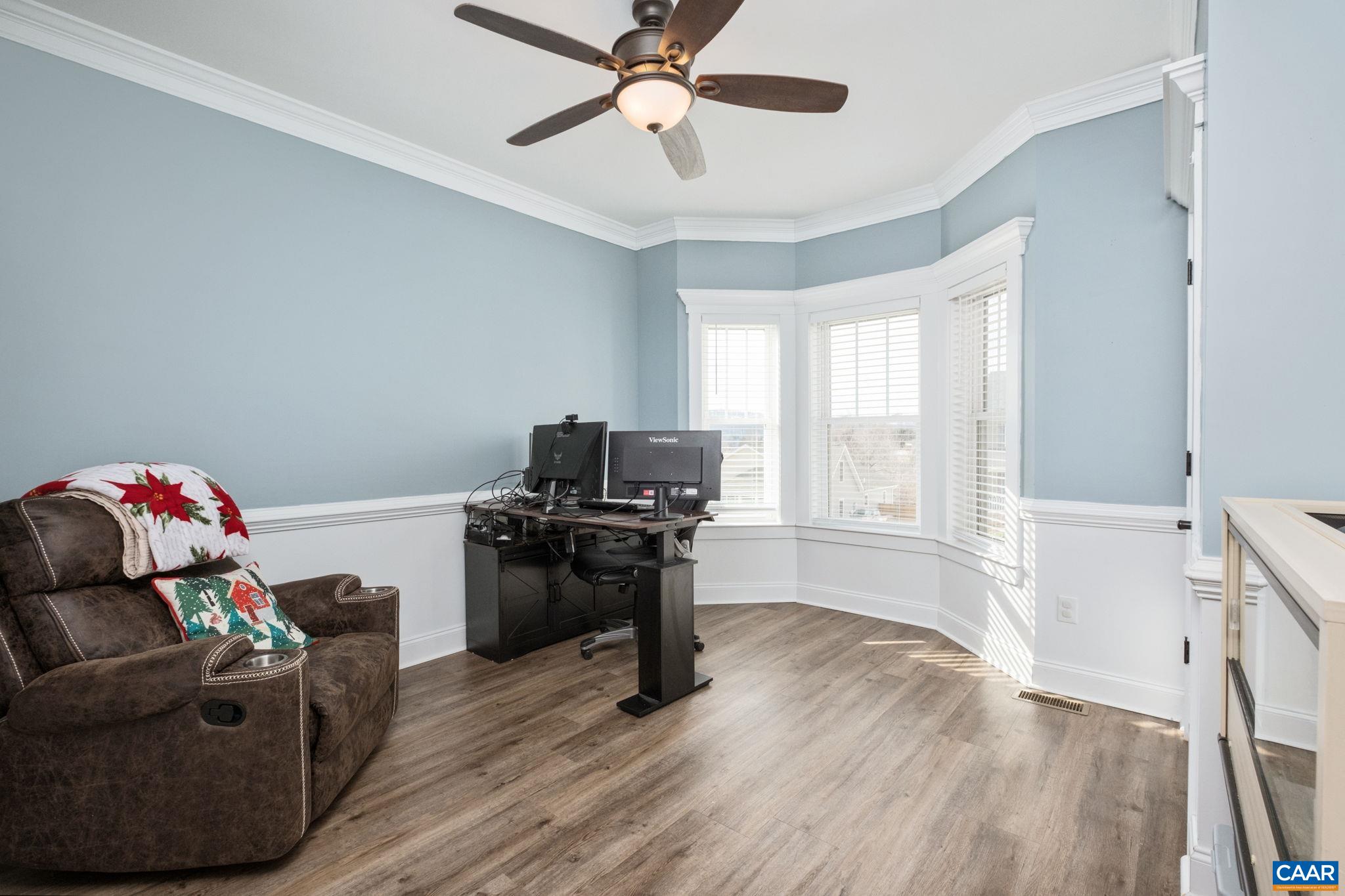 The main level features a home office with French doors and crown molding.  This spaced can be used as a play area, study, and more.