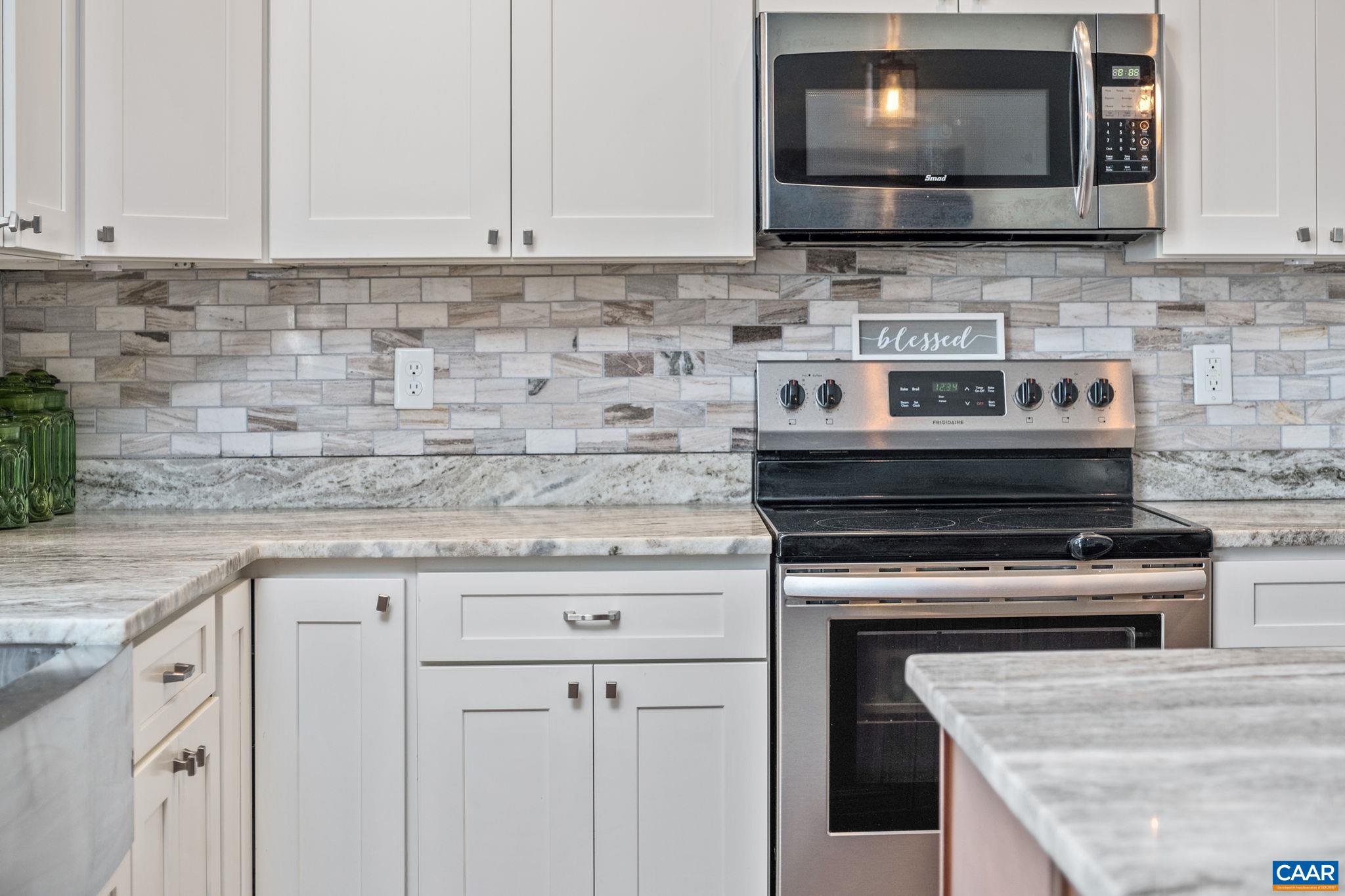 View of granite countertops, plenty of cabinetry, and stainless steel appliances.