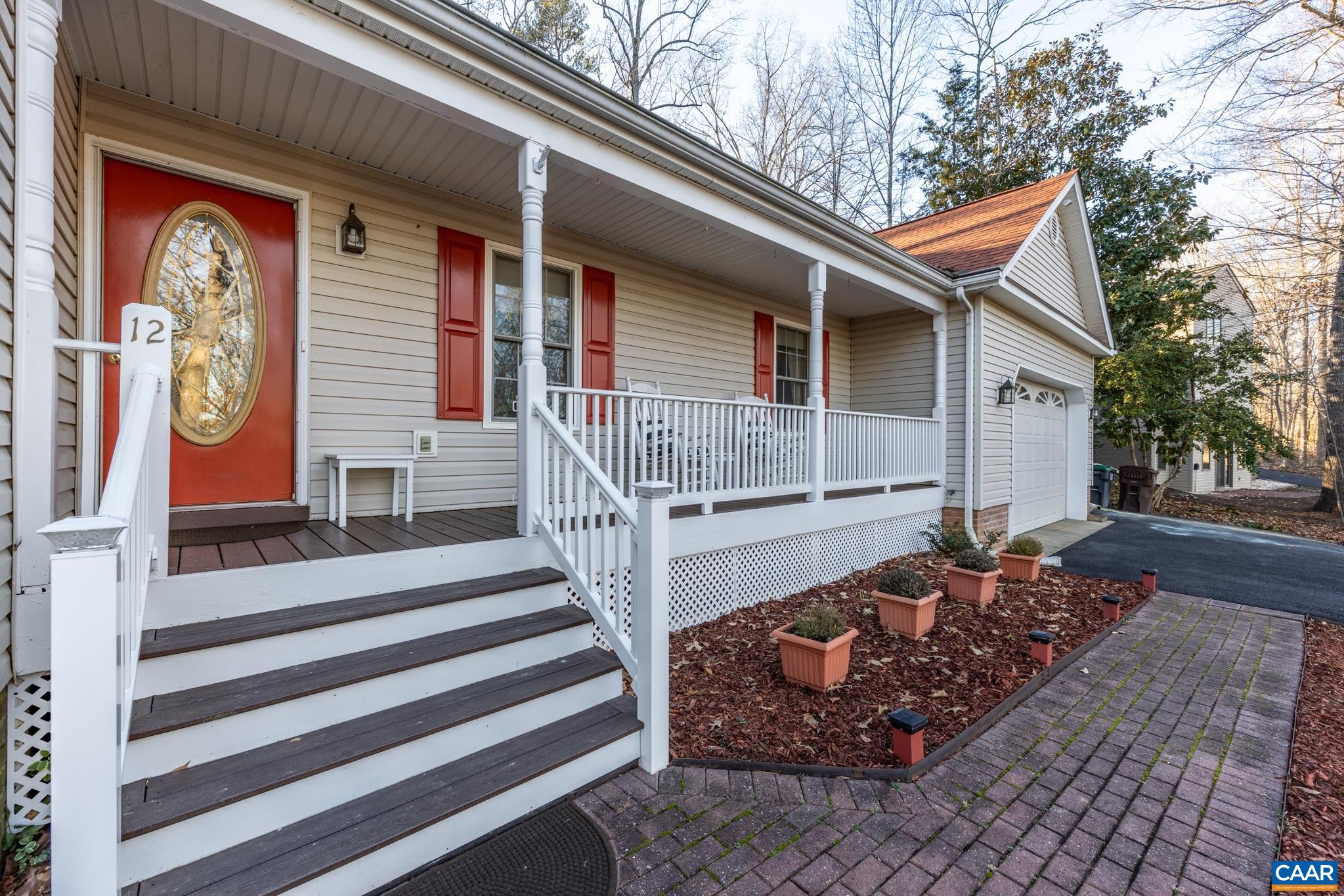 inviting Full Covered front porch capturing serene winter water views of Lake Monticello. Set on a quiet dead end street that is a quick stroll to Beach 2.