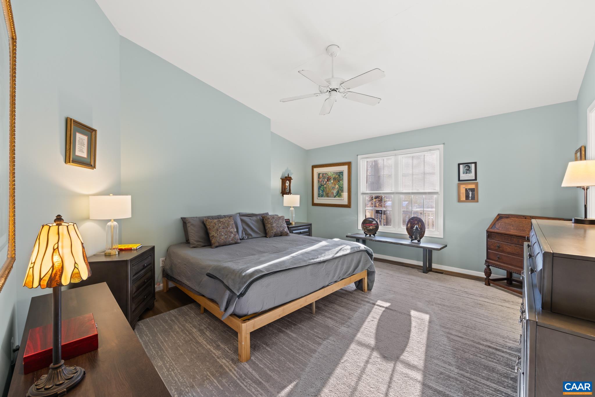 This peaceful primary offers an owners retreat with vaulted ceilings and ensuite. A California King bed in place yet still offers a generous amount of additional space for your furnishings.