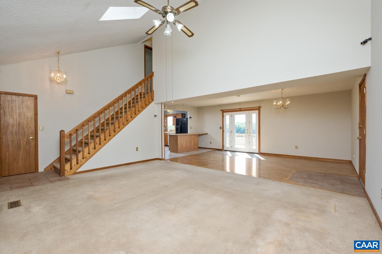 This view is from the front corner of the living room, looking to the dining room and kitchen.
