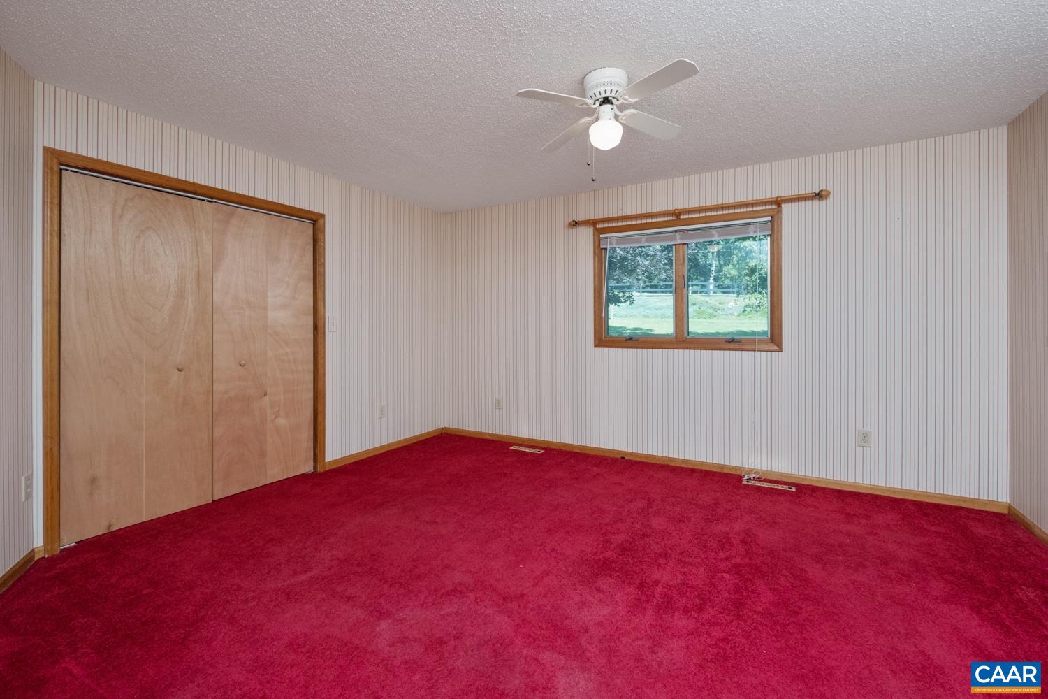 The primary bedroom is located in the front corner of the home, just beyond the kitchen.