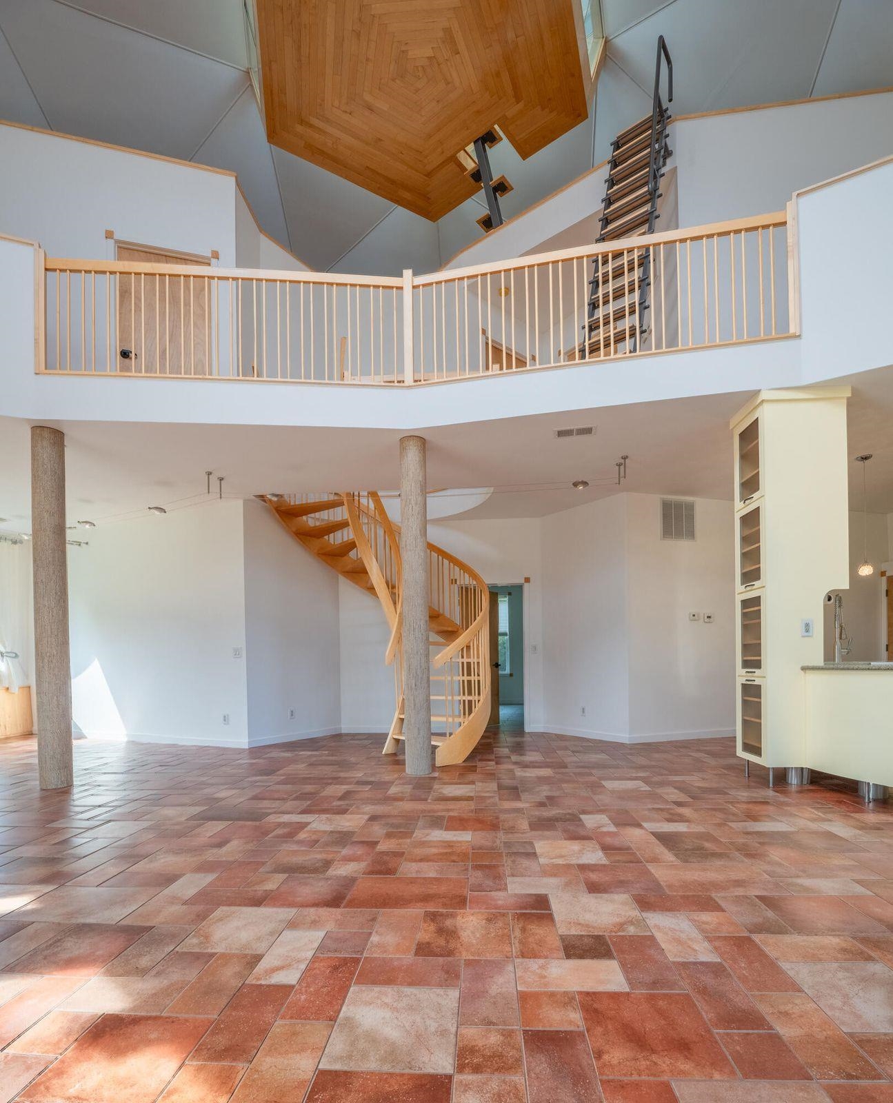 Spiral staircase ascends to the 2nd floor, and a beautifully constructed ladder takes you to the cupola.