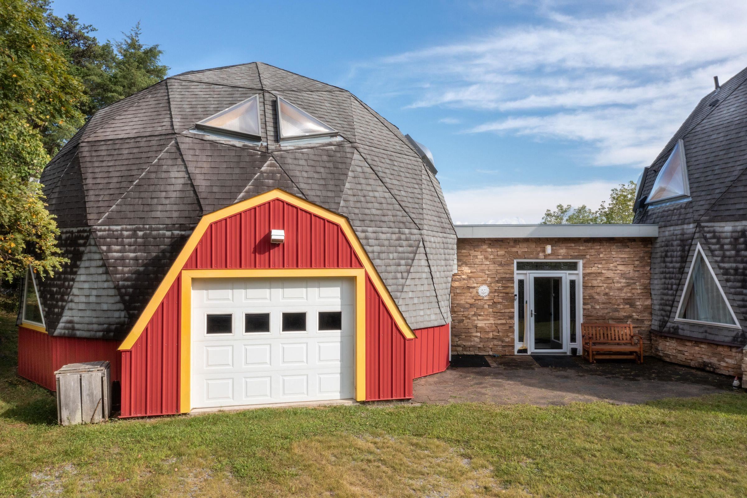 The smaller dome hosts a single car garage/storage/workshop space -- and two 2nd floor Guest Rooms with a kitchenette and Guest Bath.