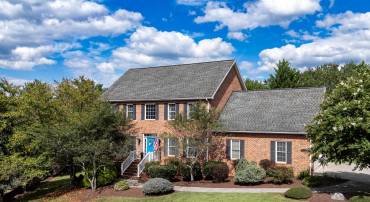 The front view of the beautiful colonial-style home located in the subdivision of Highland Park.  This home is located at the end of the cul-de-sac and features a large yard with mature landscaping, large driveway for parking, two car garage, and more!