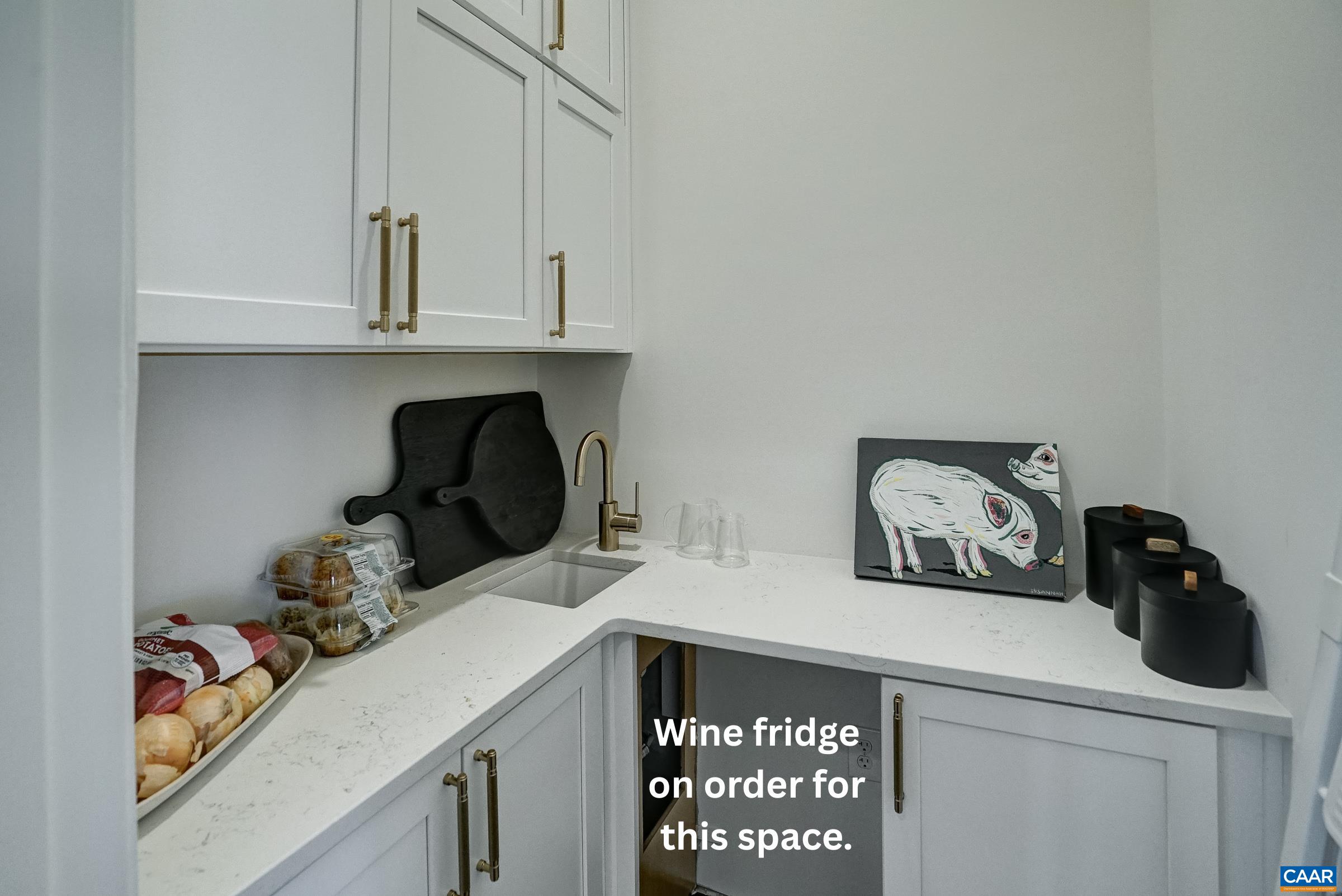 Large walk-in pantry features quartz counters, wet bar with wine cooler to be added.