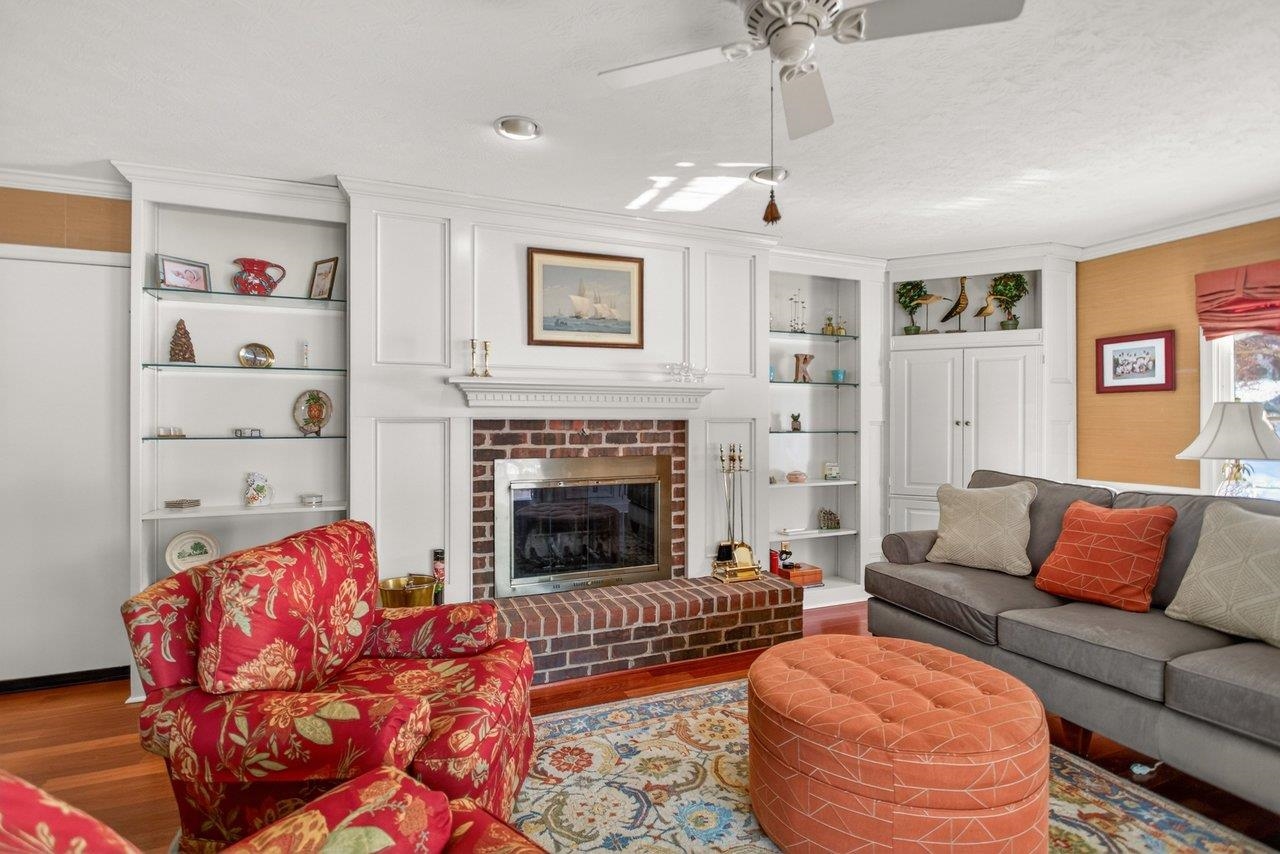 The built-ns and fireplace combine to create a welcoming space. The floors here are solid cherry