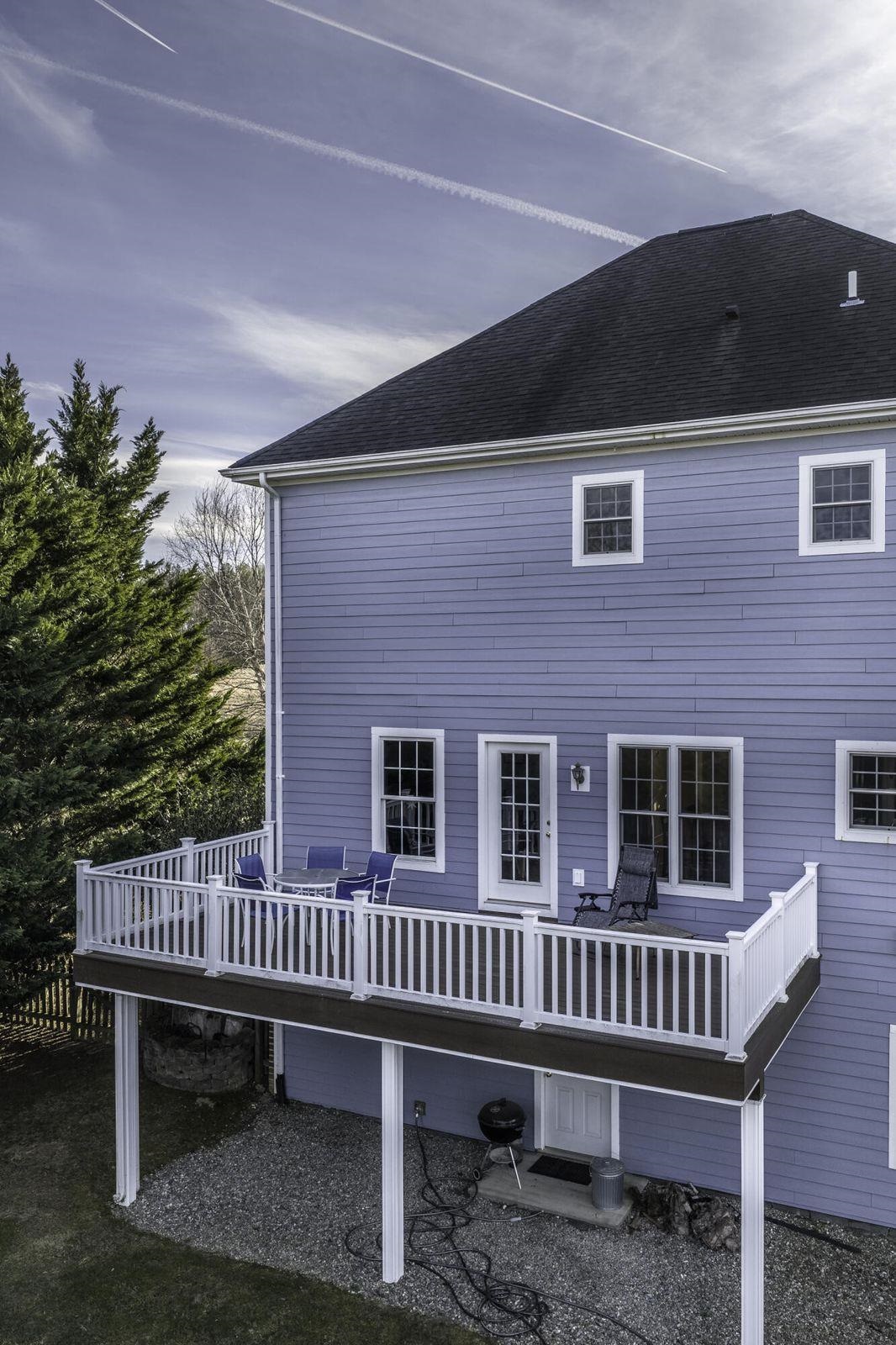 The rear deck offers a cover for the patio beneath it. The rear deck offers a cover for the patio beneath it.