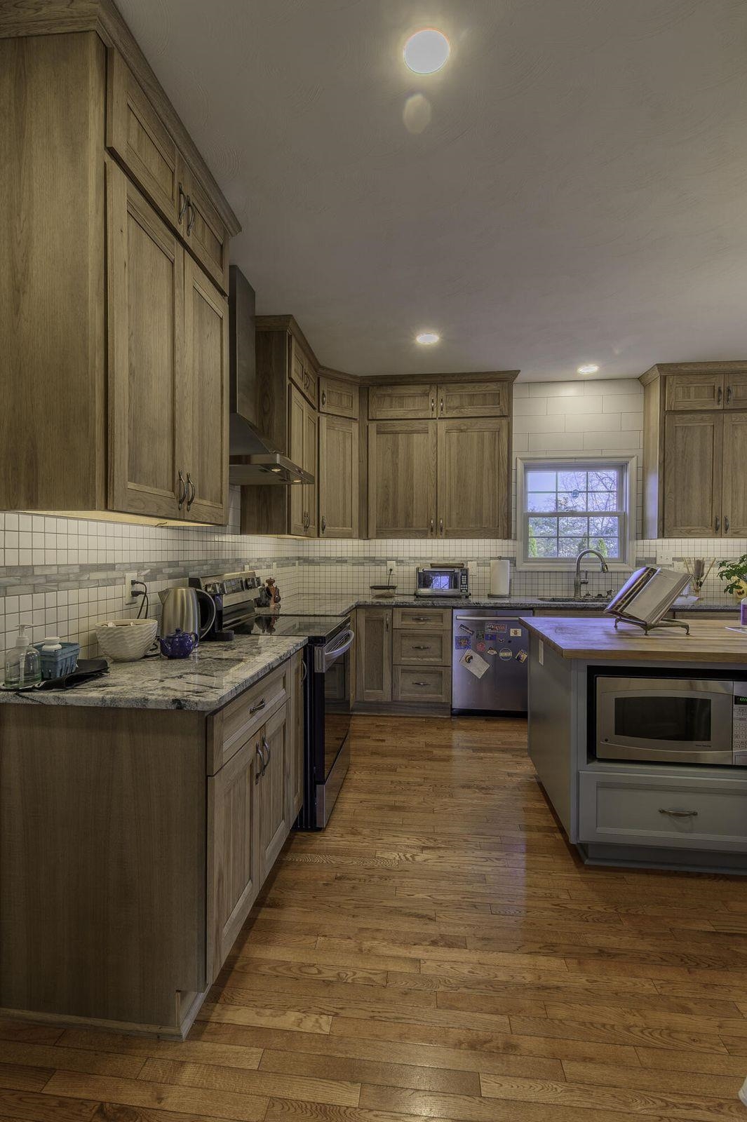 Custom-built, hickory cabinetry rises all the way up to the ceiling. Custom-built, hickory cabinetry rises all the way up to the ceiling.