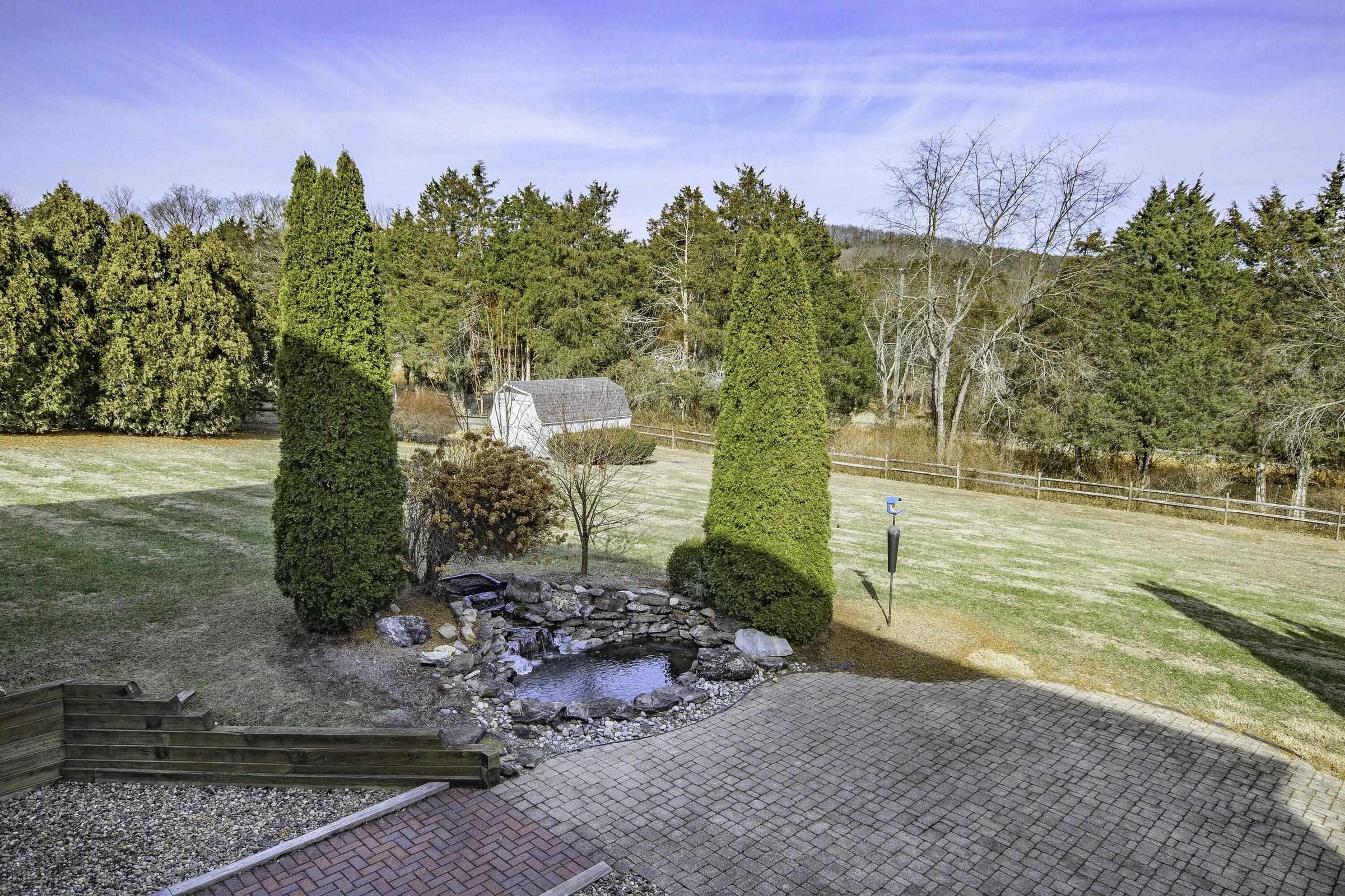 A lovely fishpond with waterfall enhances outdoor picnics. A lovely fishpond with waterfall enhances outdoor picnics.