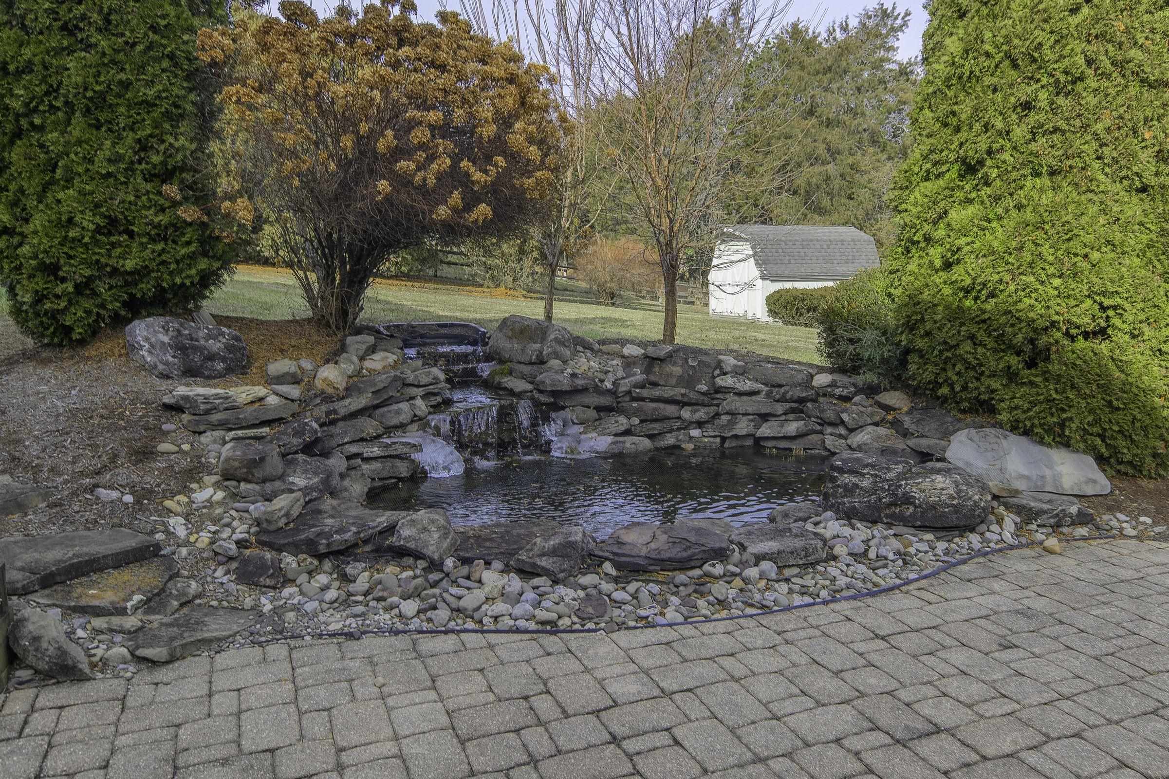 Patio accessible from Lower level. Fish pond with waterfall. Patio accessible from Lower level. Fish pond with waterfall.