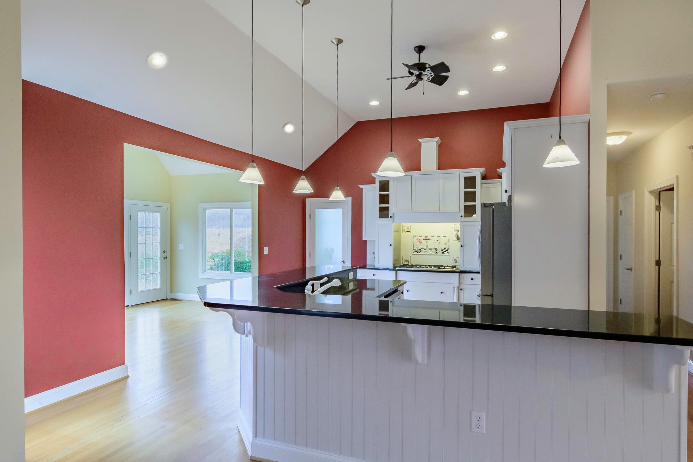 Looking through the kitchen you can seen the sunroom, everyone's favorite place to eat.