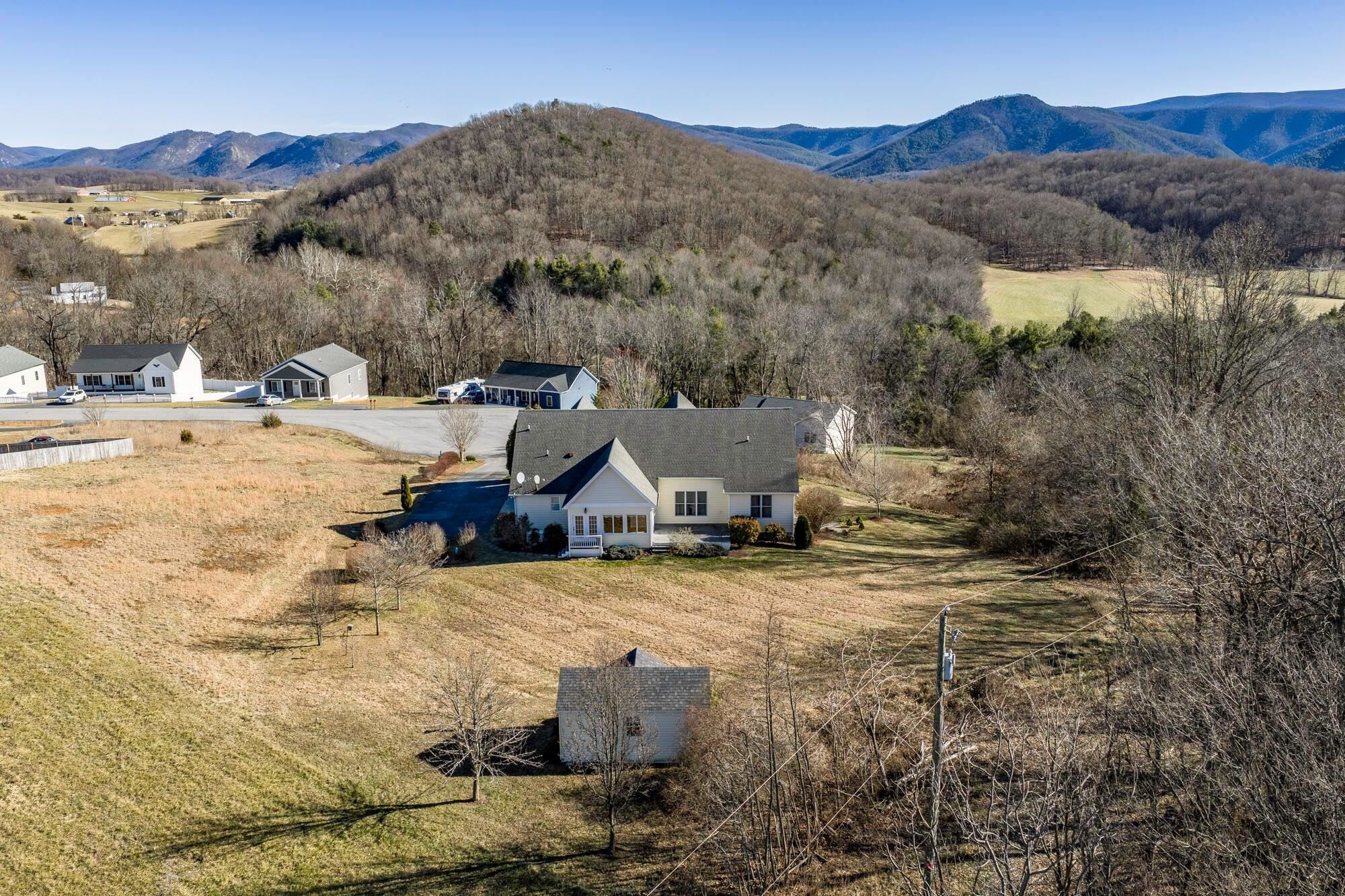 Bird's eye view of the back of the house, including the garden shed and expansive lawns.