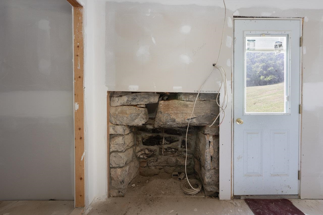Stone fireplace inside the south door makes a lovely addition to the kitchen area.